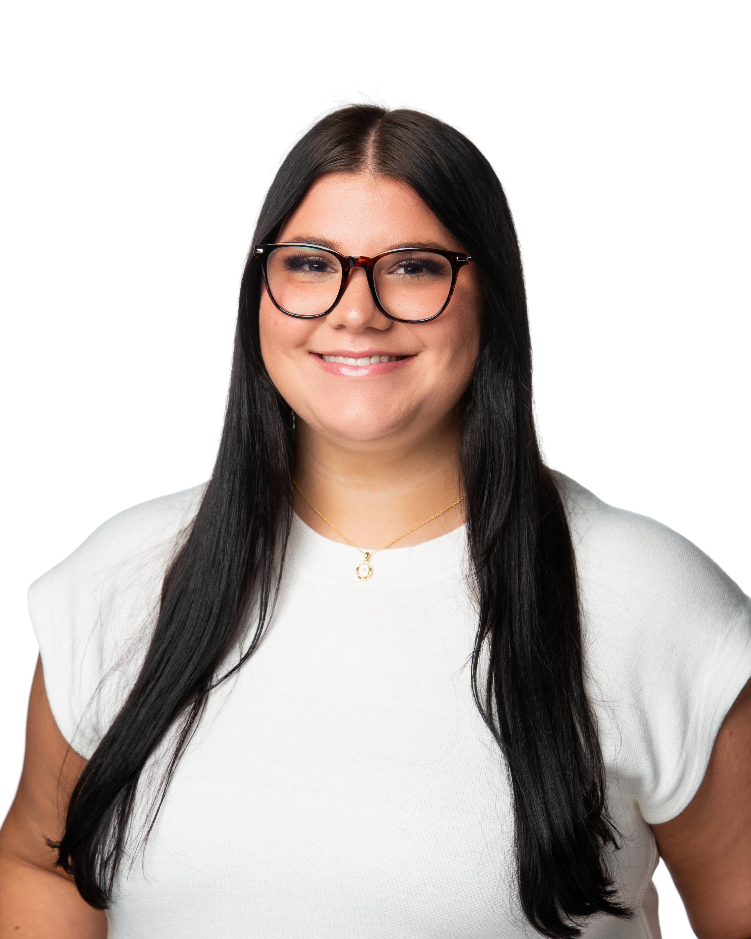 A woman with long dark hair wearing glasses, a white top, and a gold necklace is smiling, against a white background.