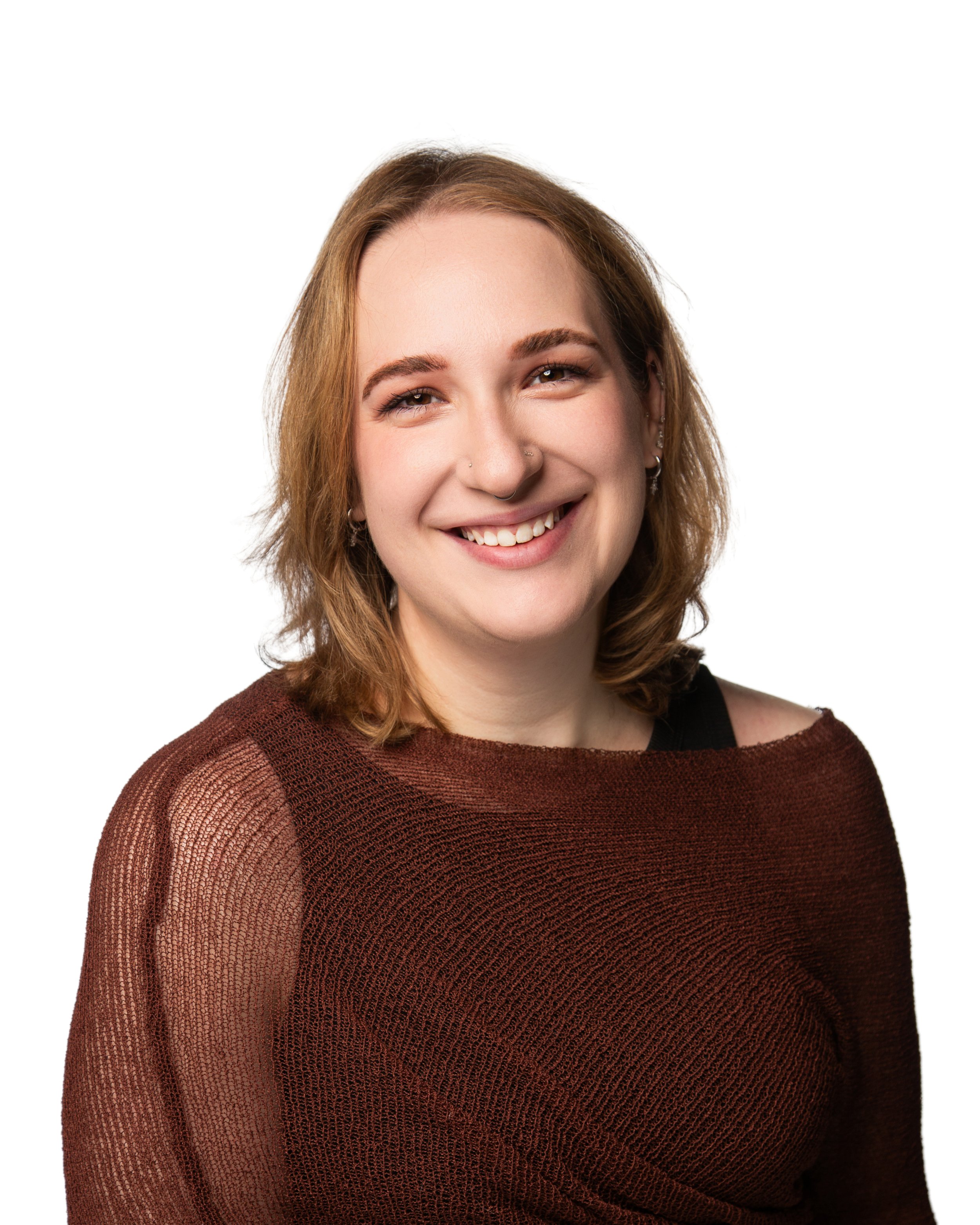 Portrait of a smiling young woman with light brown hair, wearing a maroon semi-transparent sweater over a black top, against a white background.