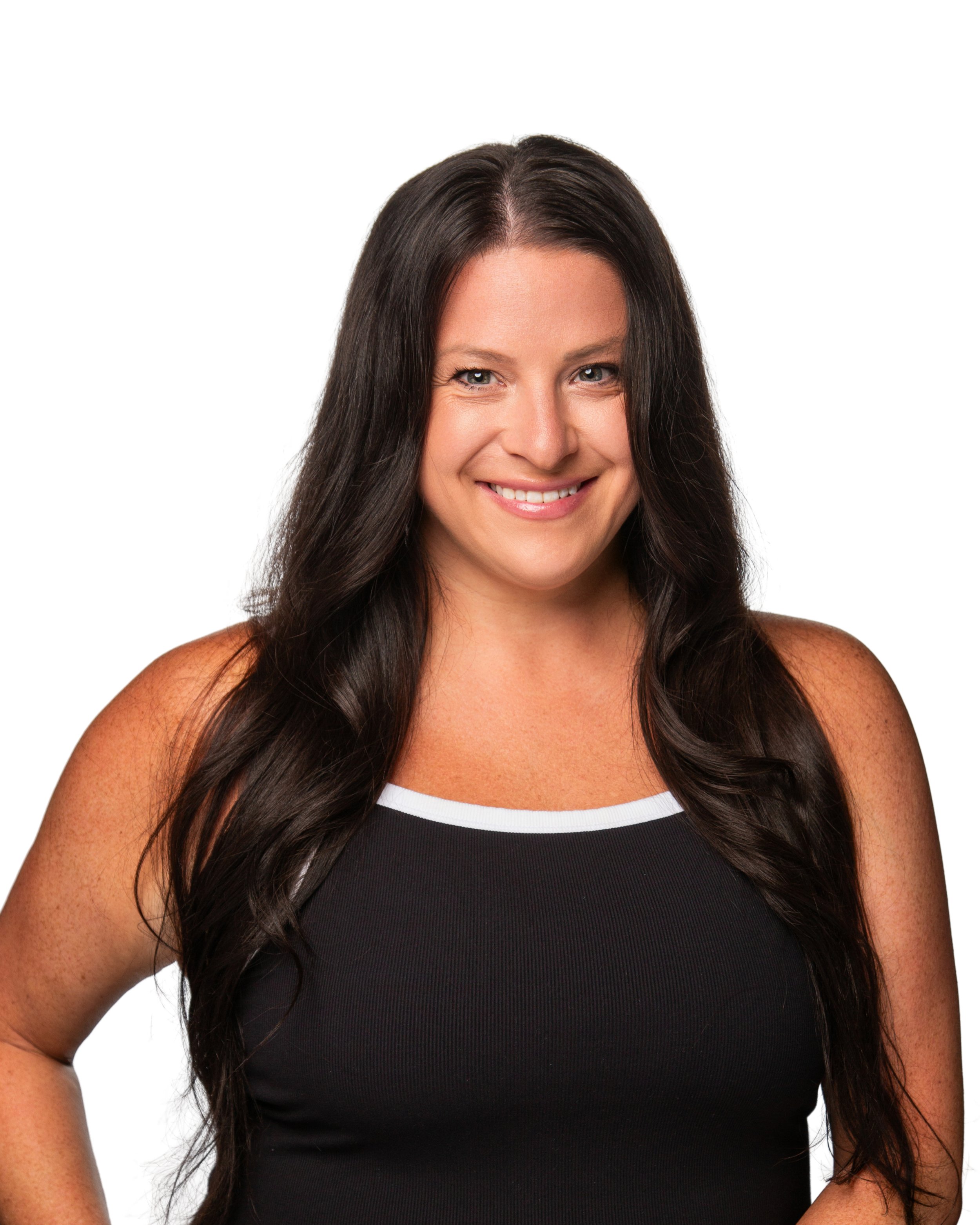 A woman with long dark hair wearing a black tank top with white trim, smiling, against a white background.