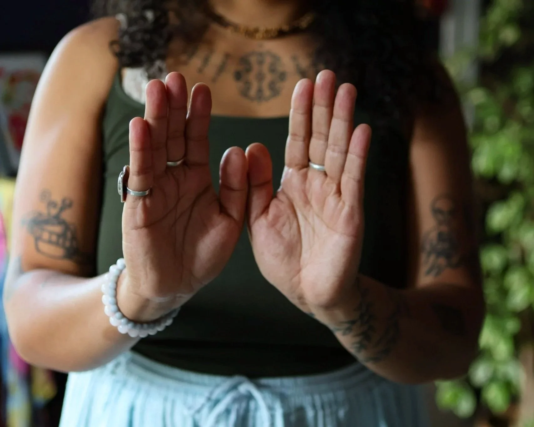 A close-up image of Dawnbee's hands in front of her chest, palms facing outwards