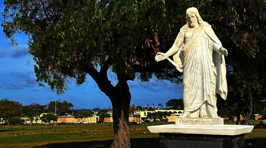 This statue of Jesus is said to watch people as they walk through Diamond Head Memorial Cemetery in haunted Honolulu