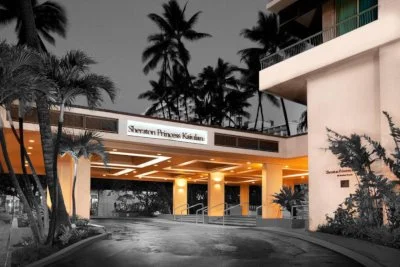 Black and white with spot color image of the haunted Sheraton Princess Kaiulani Hotel in Waikiki