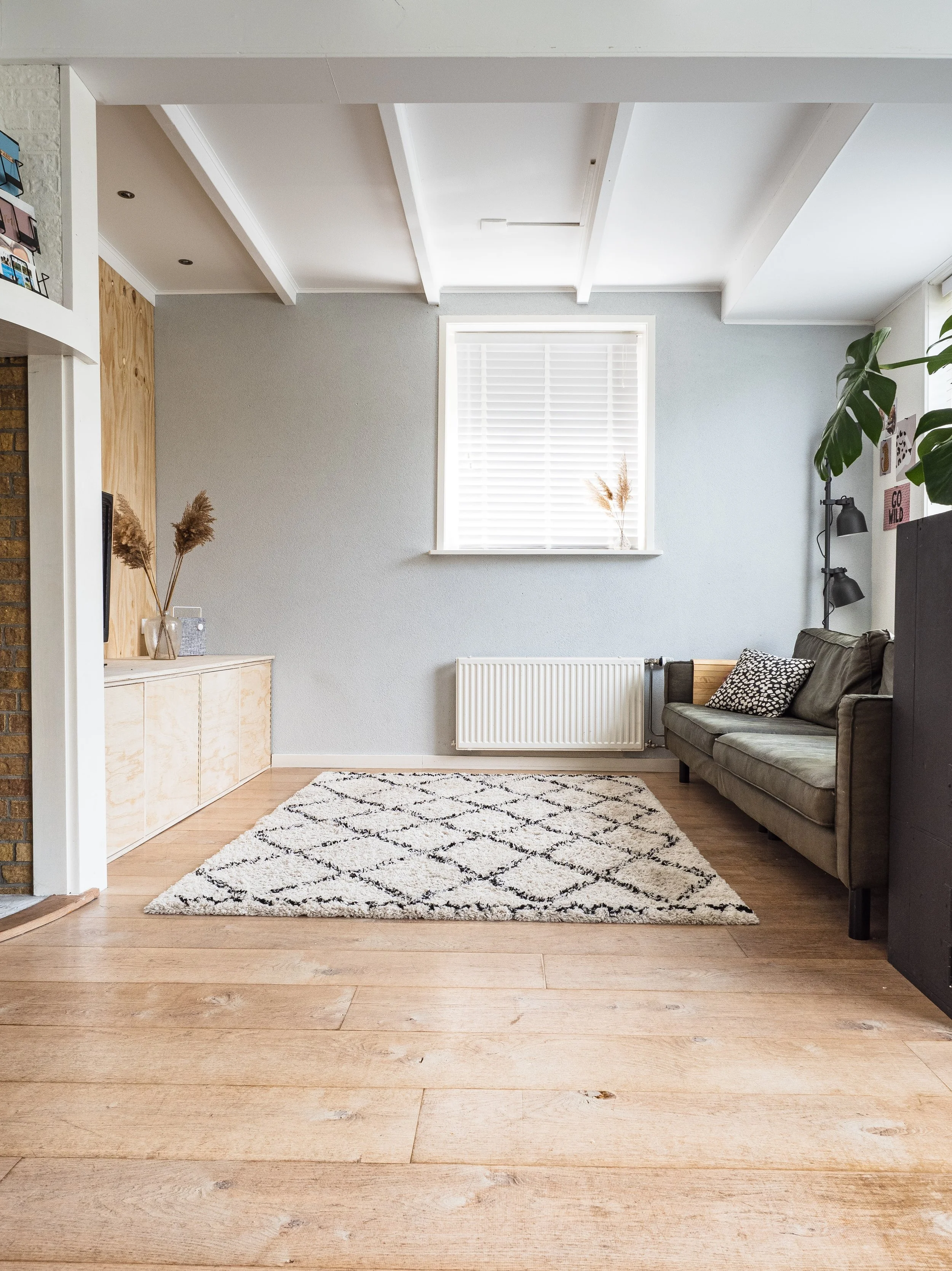Booking with The Salty Broom means that you are on your way to a clean space. You’ll want to book a recurring clean after you see how we make your space sparkle. This image is of a clean living room with a rug, couch and some decor.