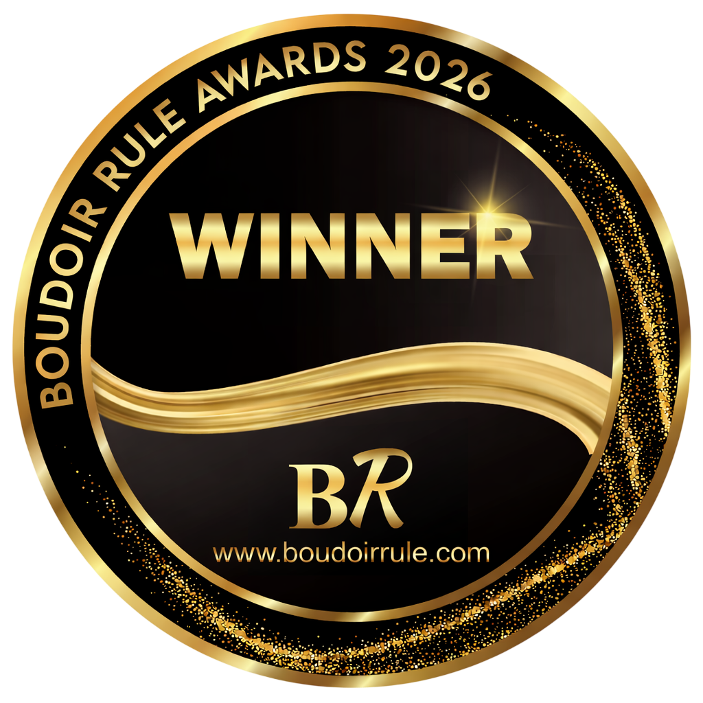 Design of a circular award badge with gold and black colors, displaying the words "BOUDOIR RULE AWARDS 2026 WINNER" along with the BR logo and website URL www.boudoirrule.com.