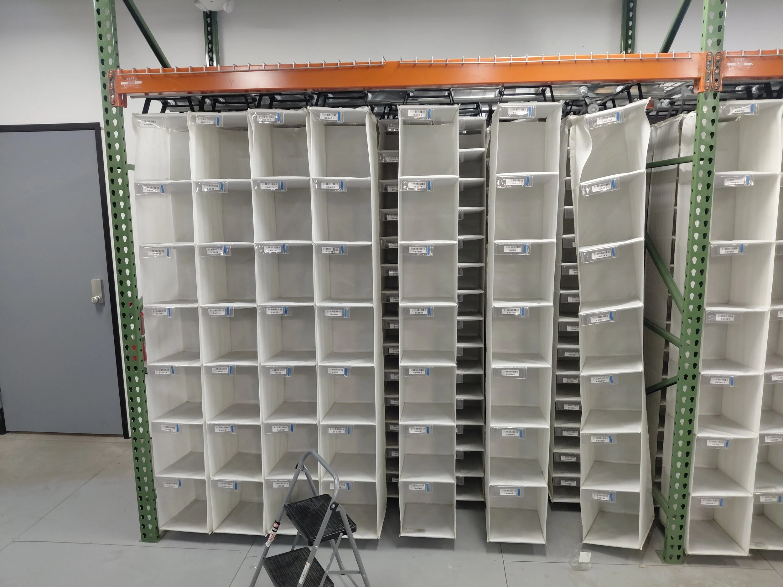Storage Racking Speed Cell. 162 compartments in 27 columns of 6 each. They hang 3 rows deep and slide on a top track.