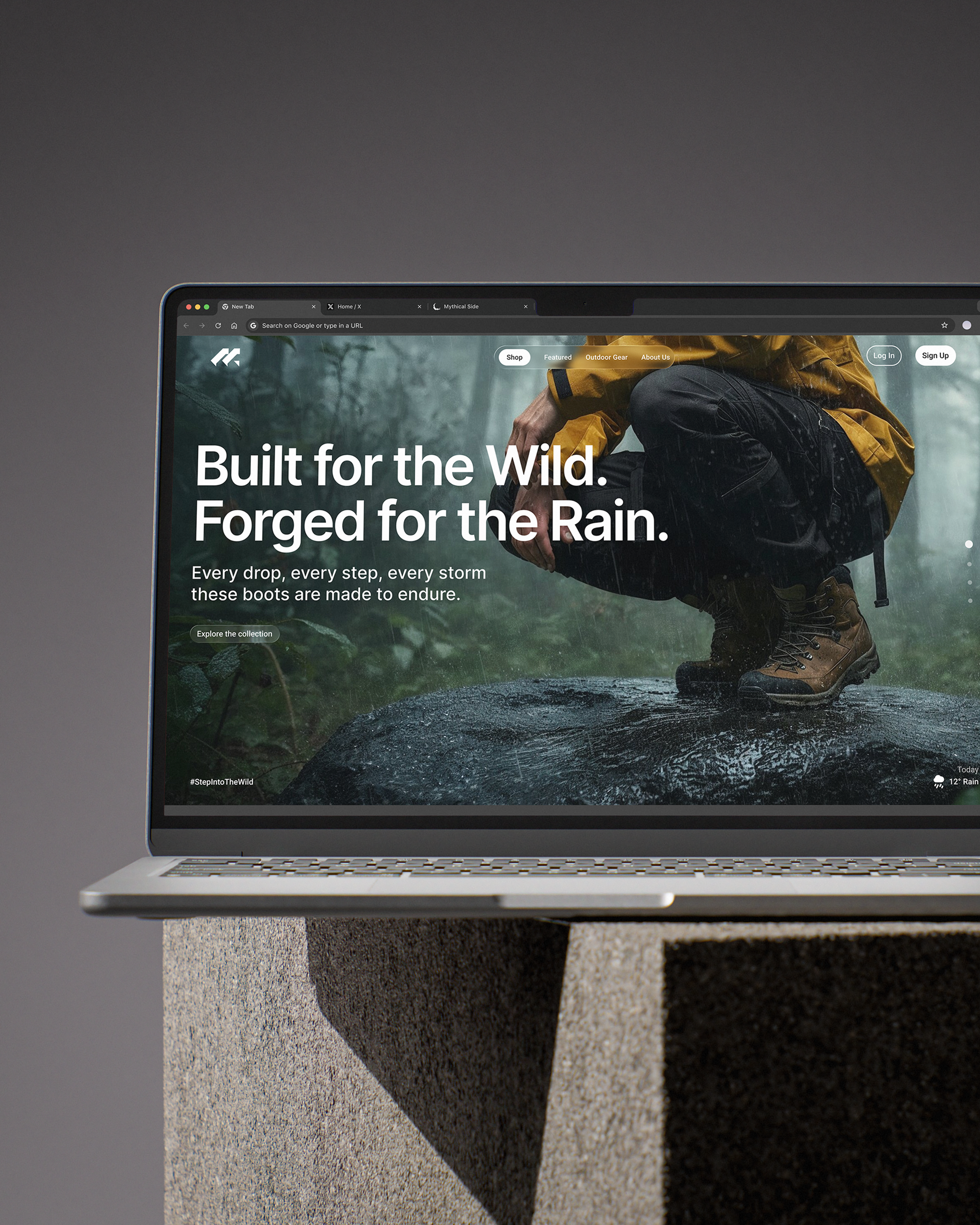 A laptop displaying a website for outdoor boots, featuring a person in rain gear squatting on wet rocks in a forested area.