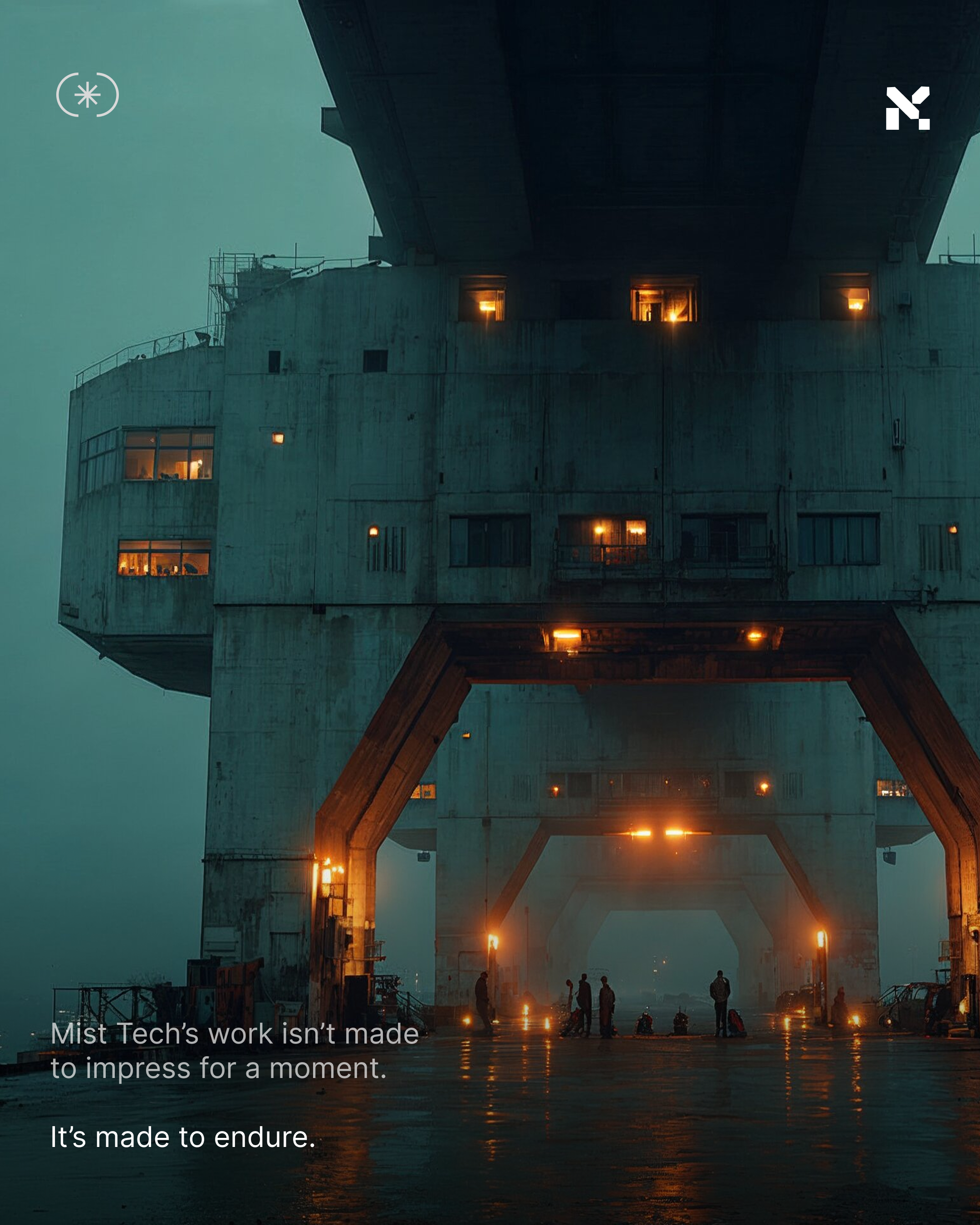 A large, industrial structure with multiple lit windows and an archway at its base, illuminated by warm lights, with several small figures and vehicles beneath it, and a foggy atmosphere.