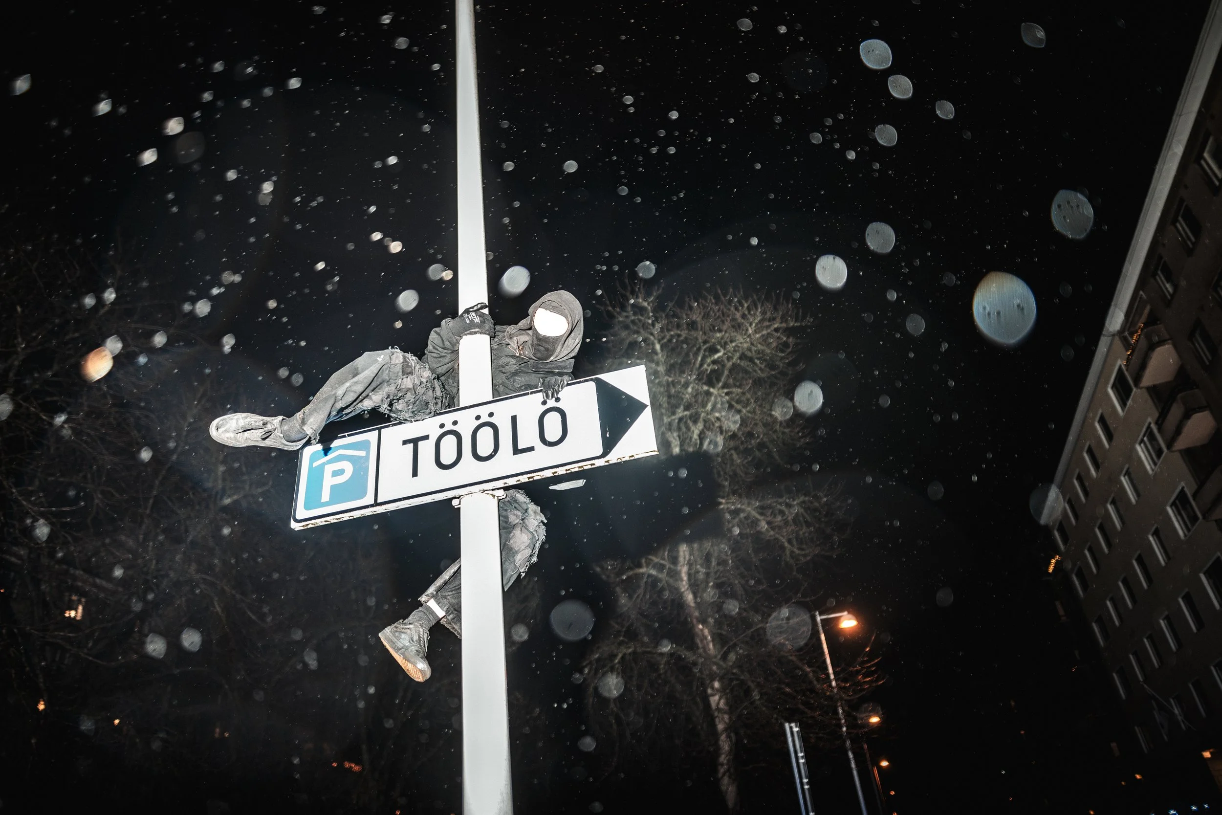 A demonstrator climbs a street sign in Töölö after the Helsinki Without Nazis counter-demonstration on Finland’s Independence Day. The district has become a recurring flashpoint where anti-fascist and far-right groups confront one another.