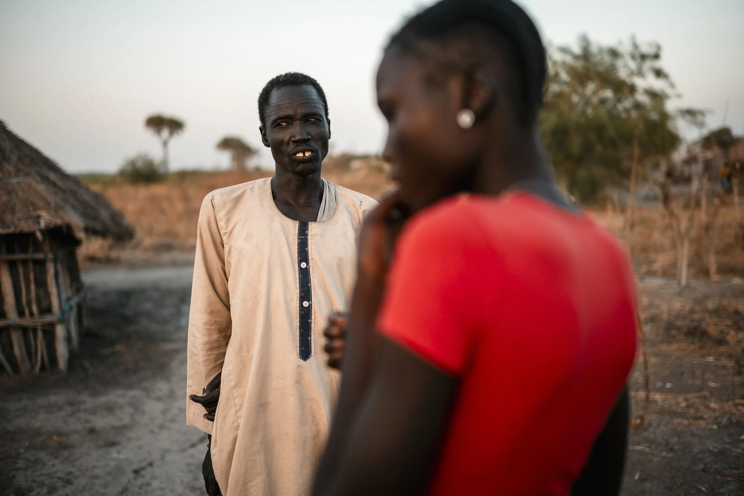 Nyaluit Tang Chuol speaks with her father, Tang Chuol Koryom, in their village of Bichul Kuon. Despite the disruption caused by flooding, the family continues to support its children’s education.