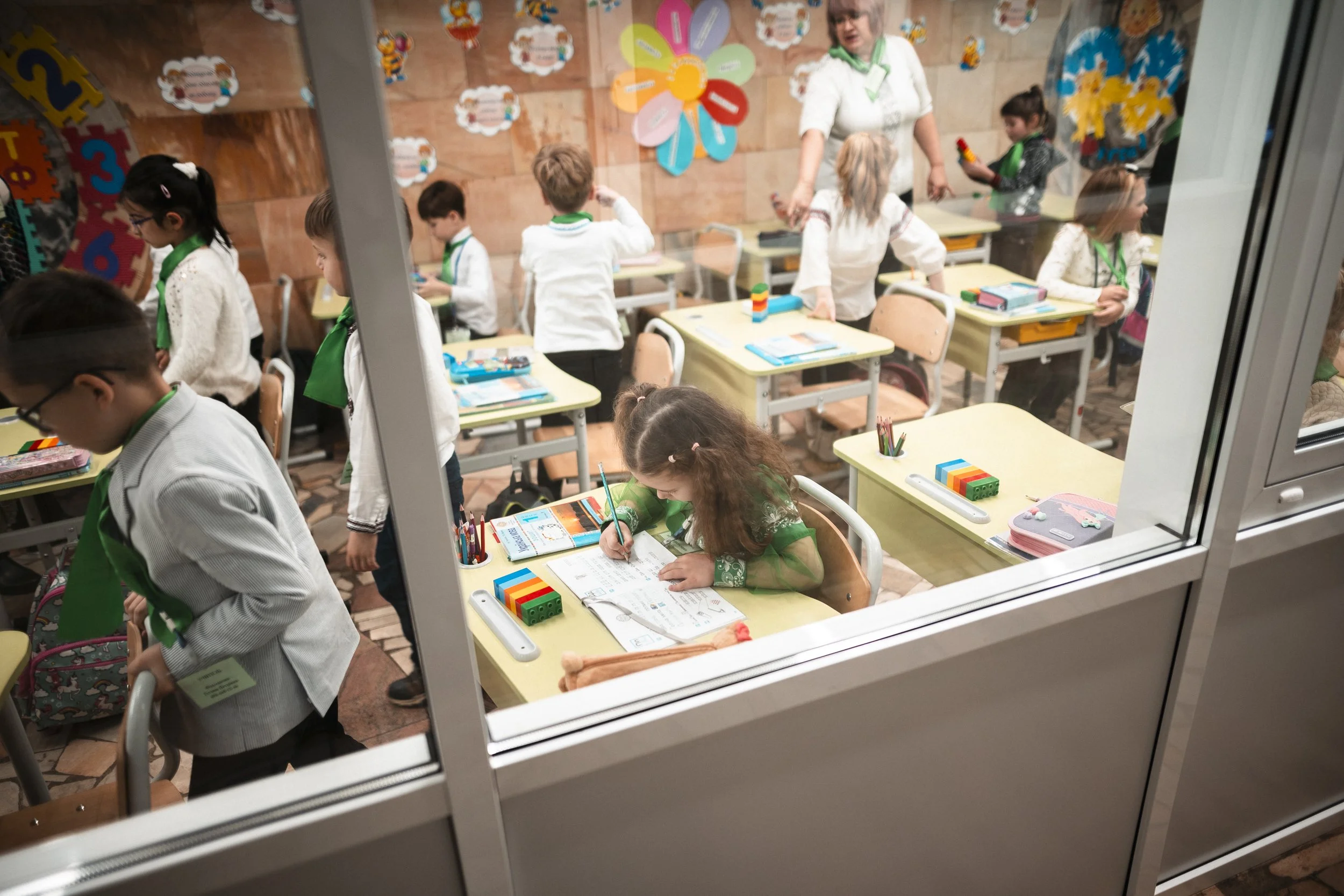 Yuliya Yurova, aged 6, holds a pencil firmly in her hand and copies the curvy letters in the exercise book. Occasionally she lets out a frustrated sigh, digs a rubber from the box and wipes it all away. Learning the letters seems to be an exacting jo