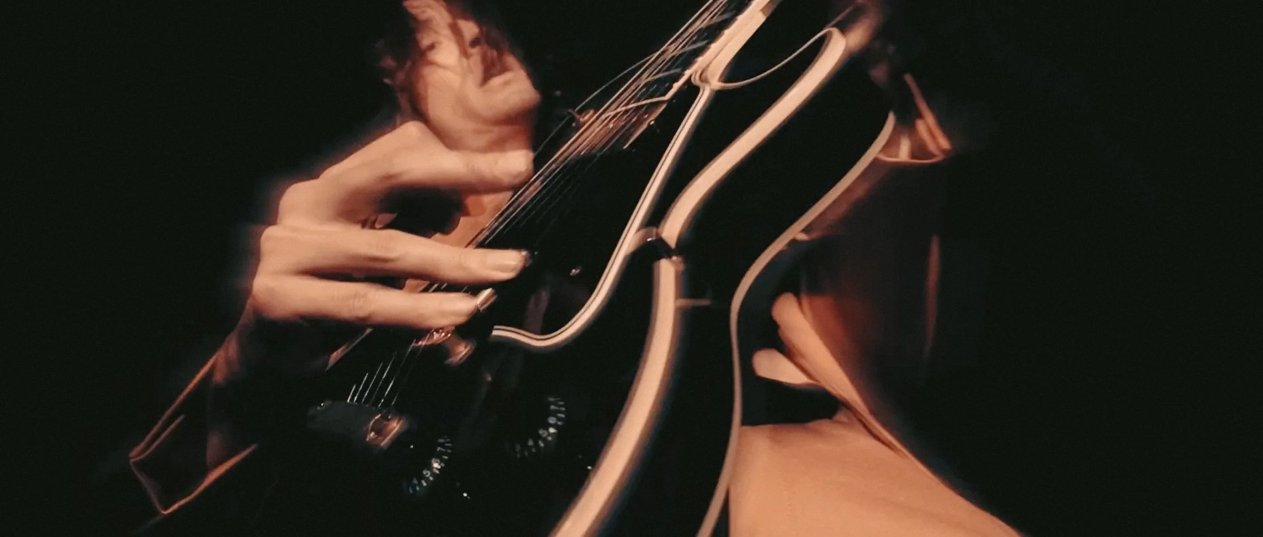 Pacer No Drama commercial still with Kyle playing guitar