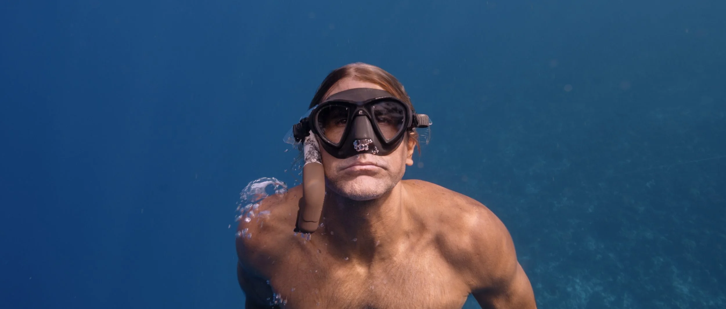 Scene from Tigers of Tahiti documentary - Denis Grosmaire swimming