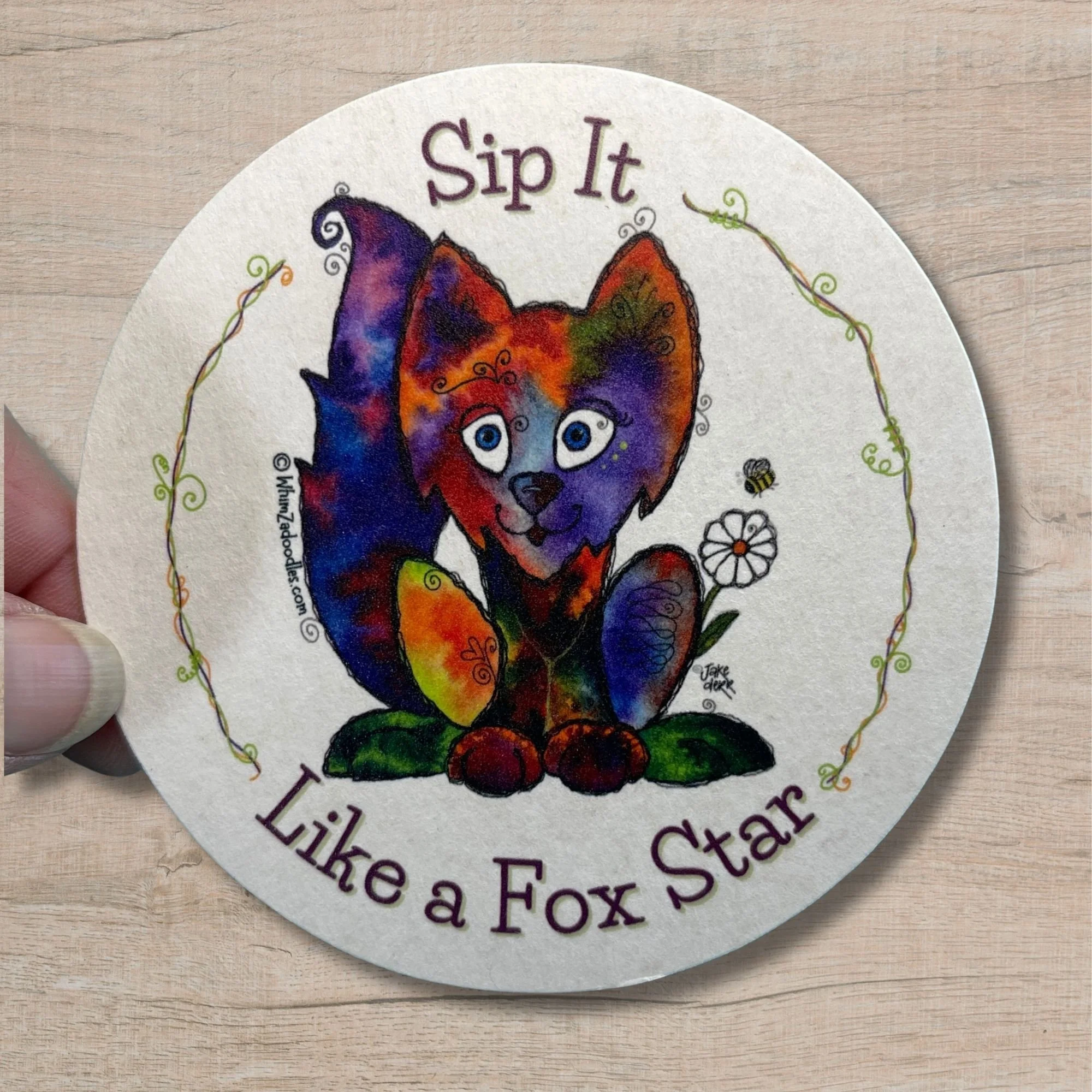Fox-themed drink coaster held in hand to demonstrate size, thickness, and scale for everyday use