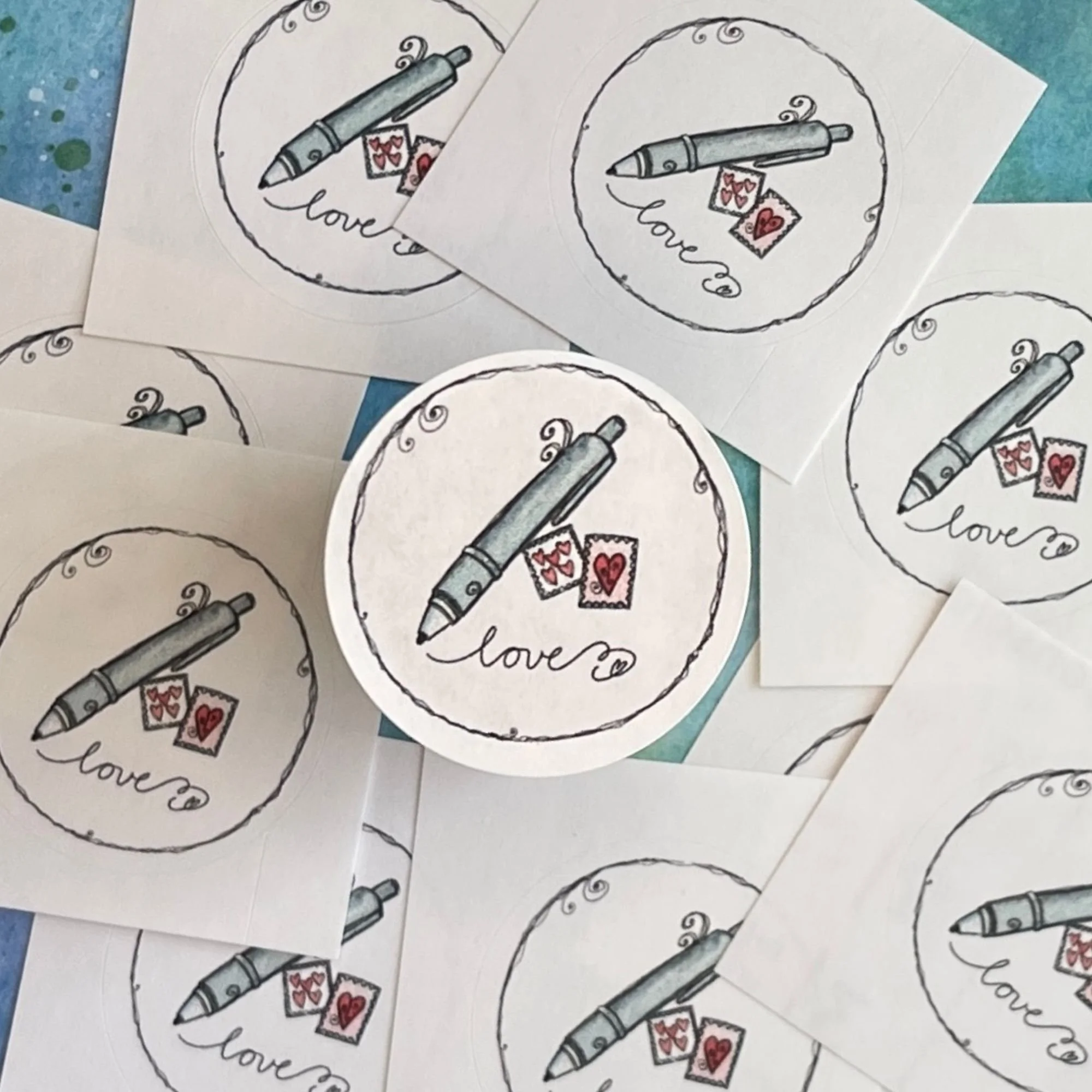 Close-up of Happy Mail envelope seal with soft blurred seals behind, showing playful lettering and whimsical details