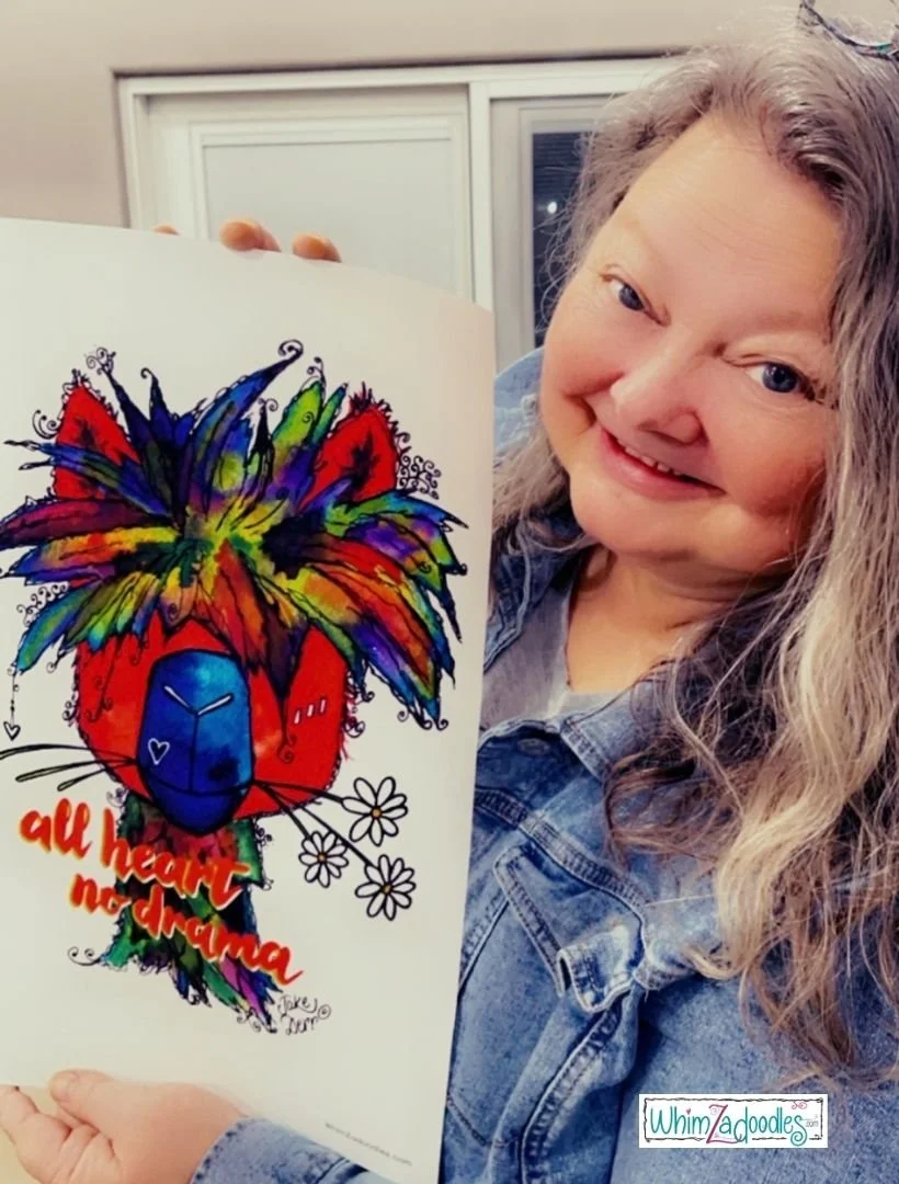 Artist, Jake Derr, holding a test print of the All Heart - No Drama llama.