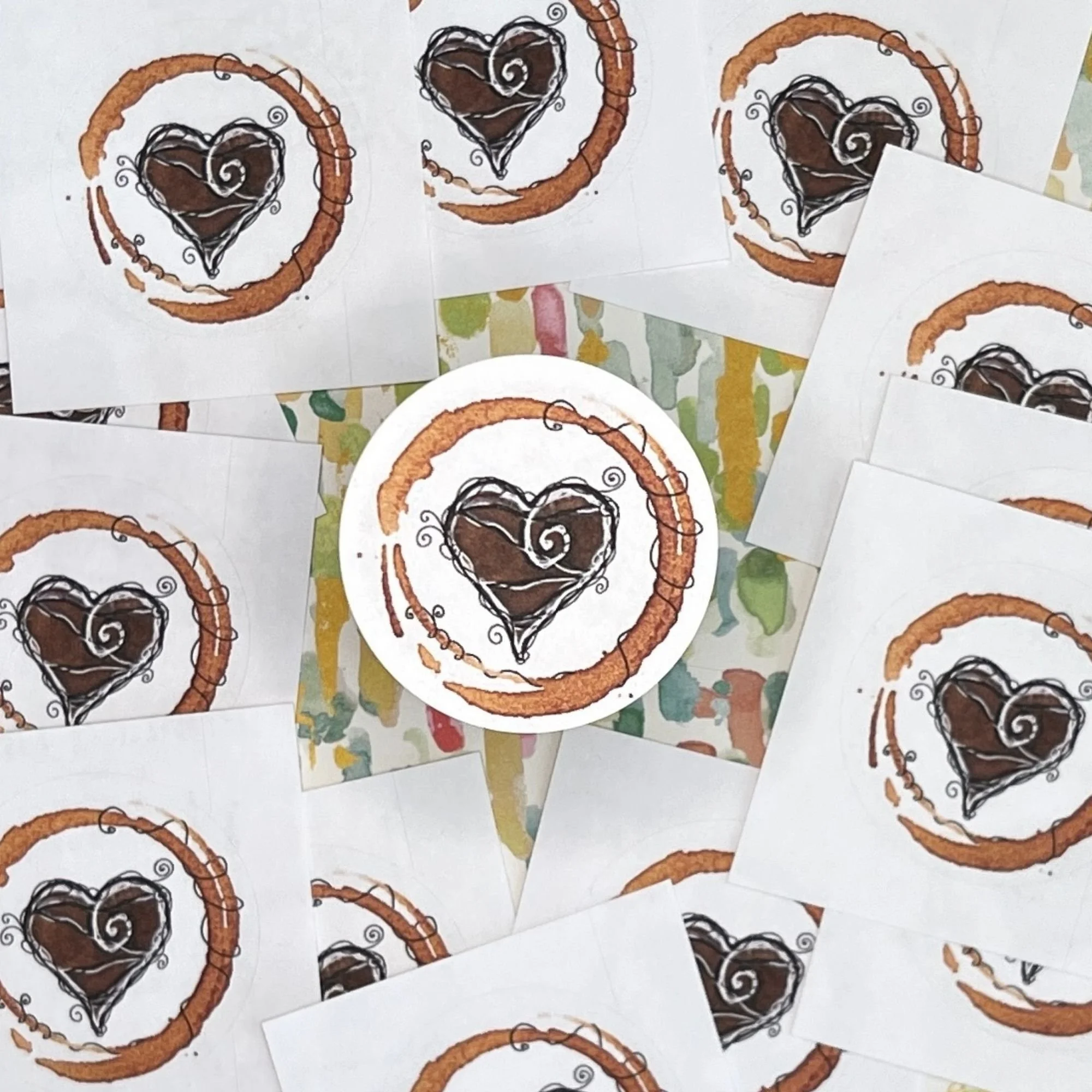 Close-up of Latte Love envelope seal showing espresso-painted heart with swirling doodle lines and textured coffee stain ring.jpg