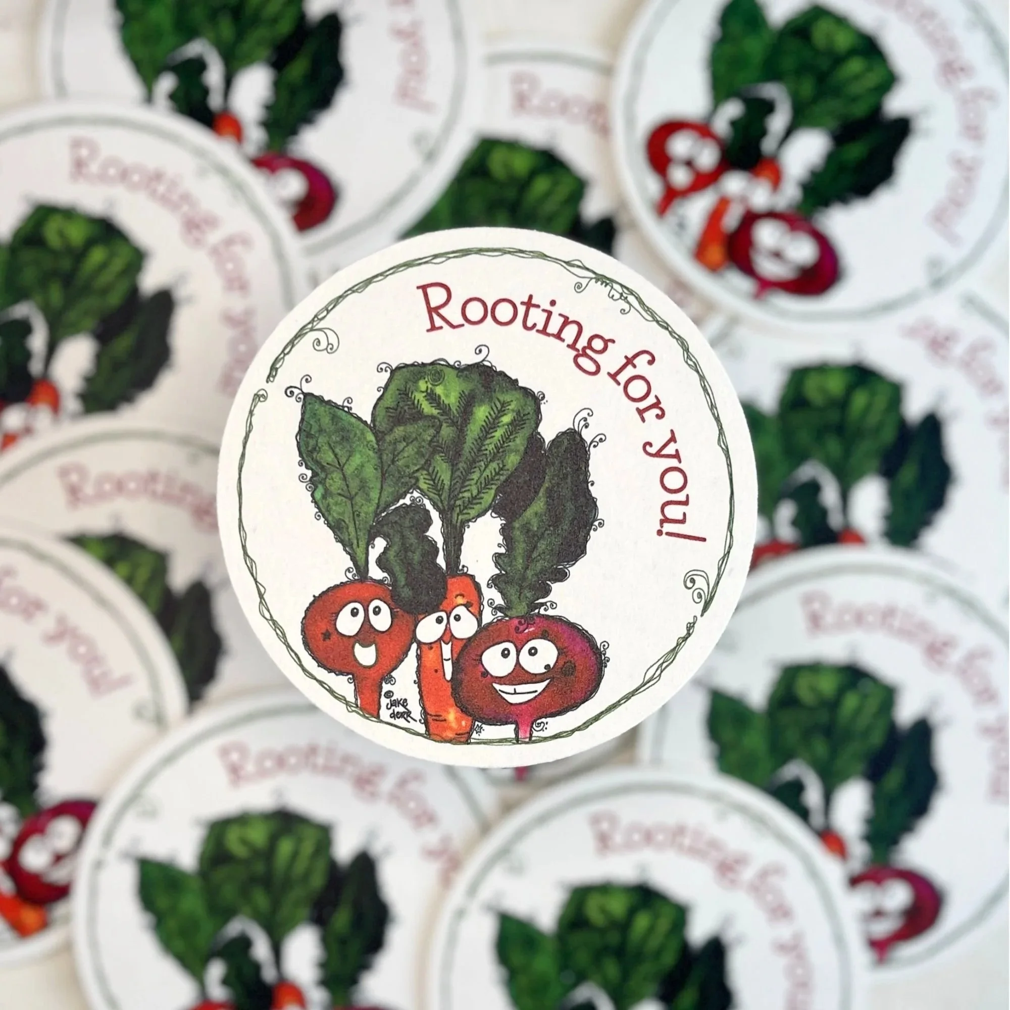 close view of beet carrot and radish with rooting for you message with softly blurred coasters behind