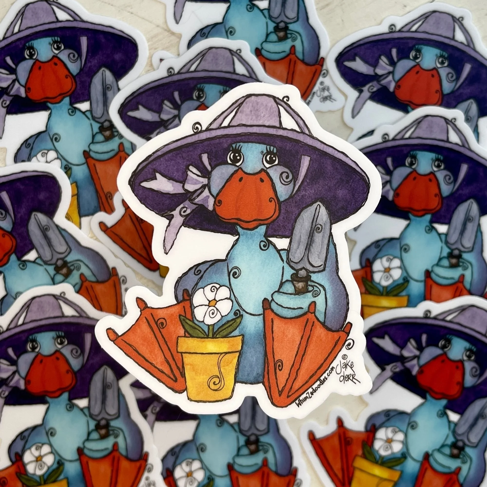 Detailed close view of Spring Duck sticker showing orange feet, purple hat, and small trowel, with softly blurred background