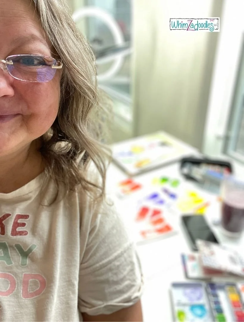 WhimZadoodle artist, Jake Derr, standing in front of her art desk in the early days of her painting journey.