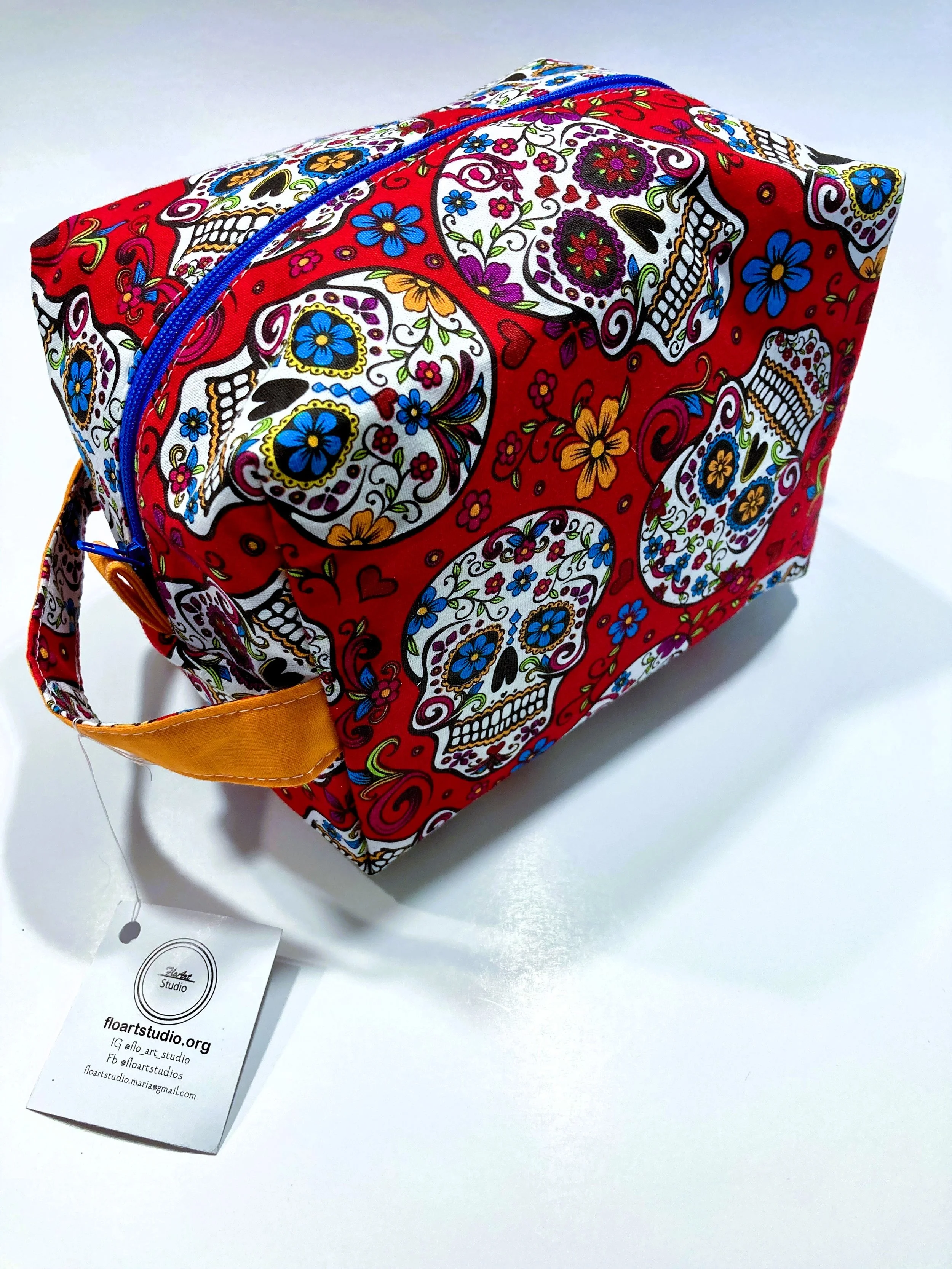 Los Muertos Sugar Skull Travel Cosmetic Red Bag with Handle Front Angle View B.jpeg