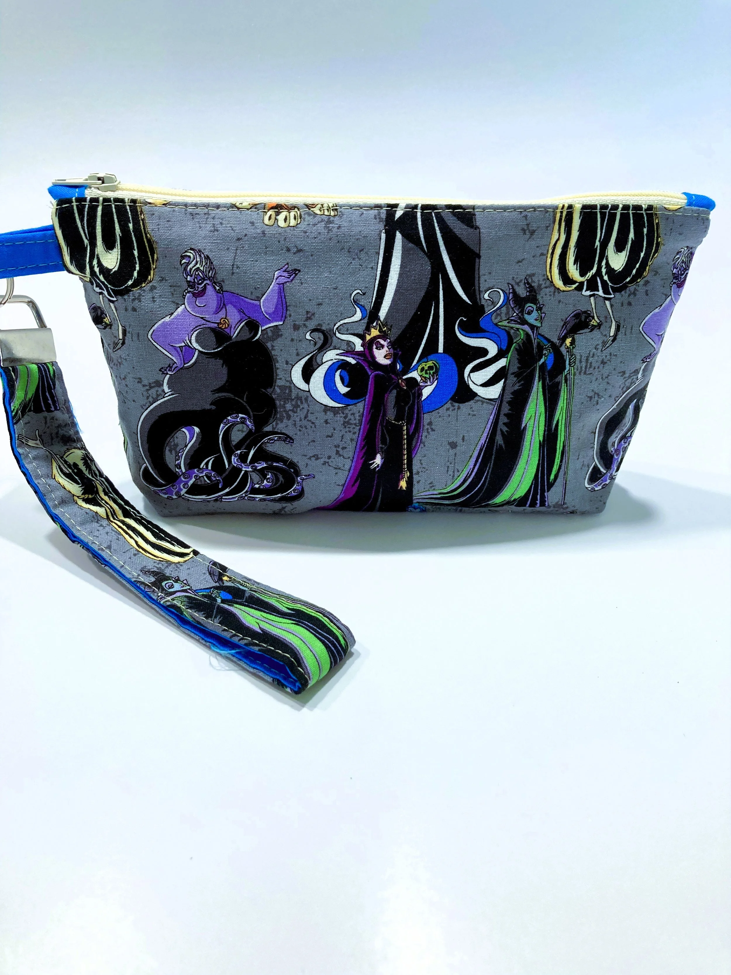 Villains Inspired Zip Wristlet Dark Fantasy Queen and Witch Grid Cosmetic Bag Grey Background Front View.jpeg