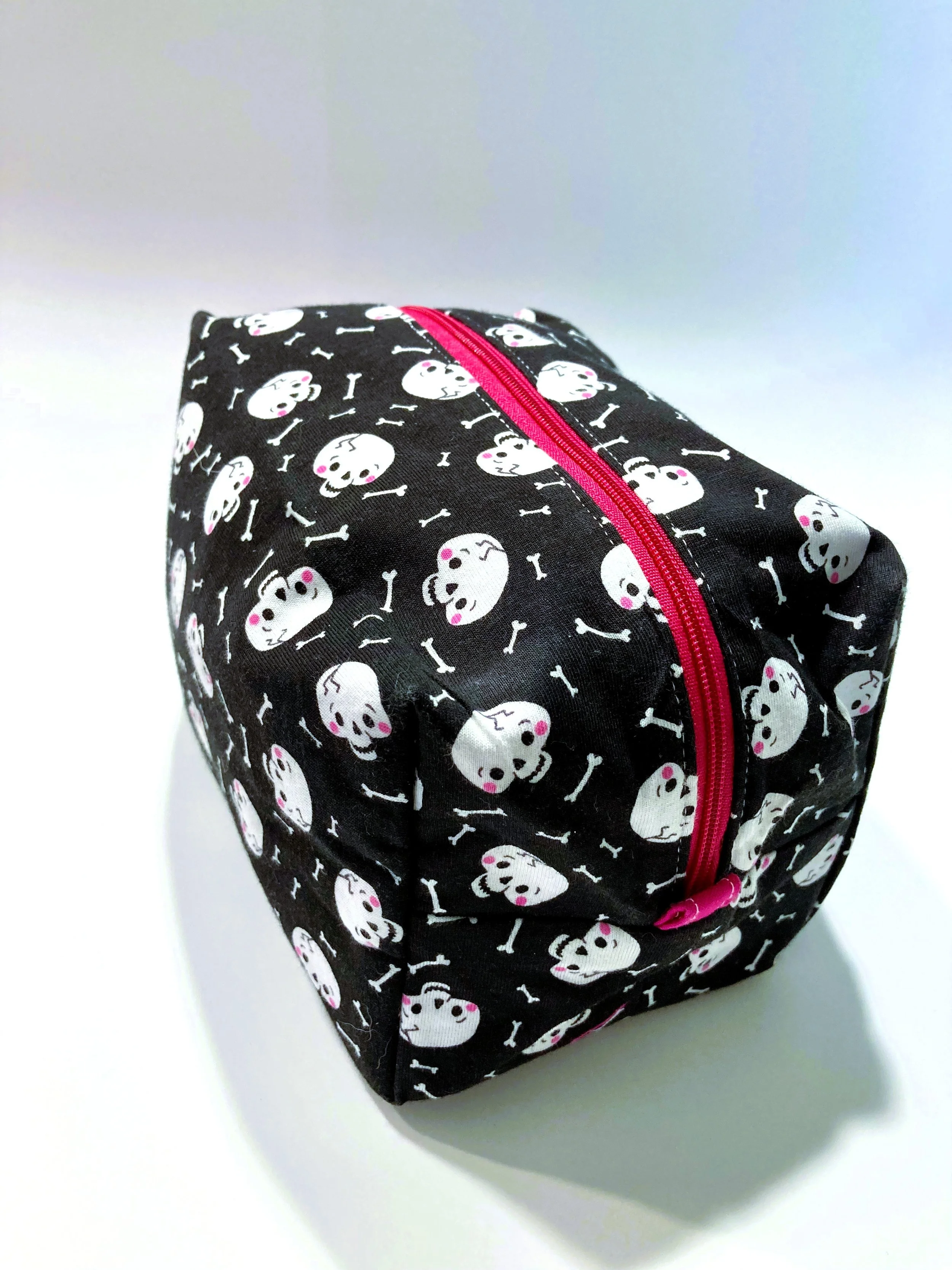 Creepy Cute Skull and Bones Travel Cosmetic Bag Pastel Goth Coquette Pink Bows Makeup Case Side View.jpeg
