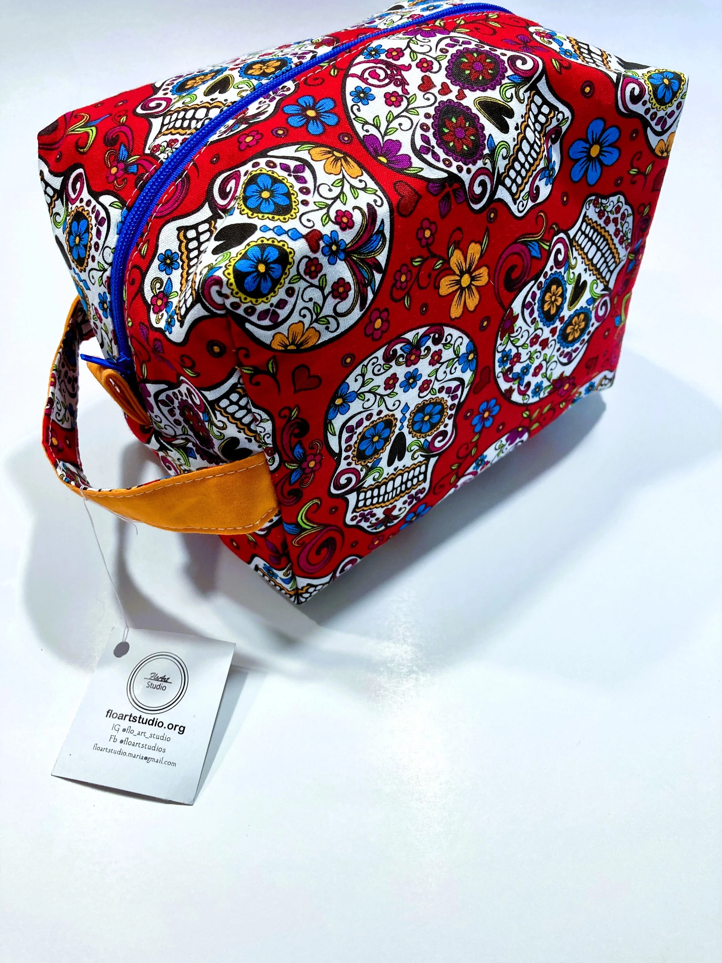 Los Muertos Sugar Skull Travel Cosmetic Red Bag with Handle Front Angle View A.jpeg