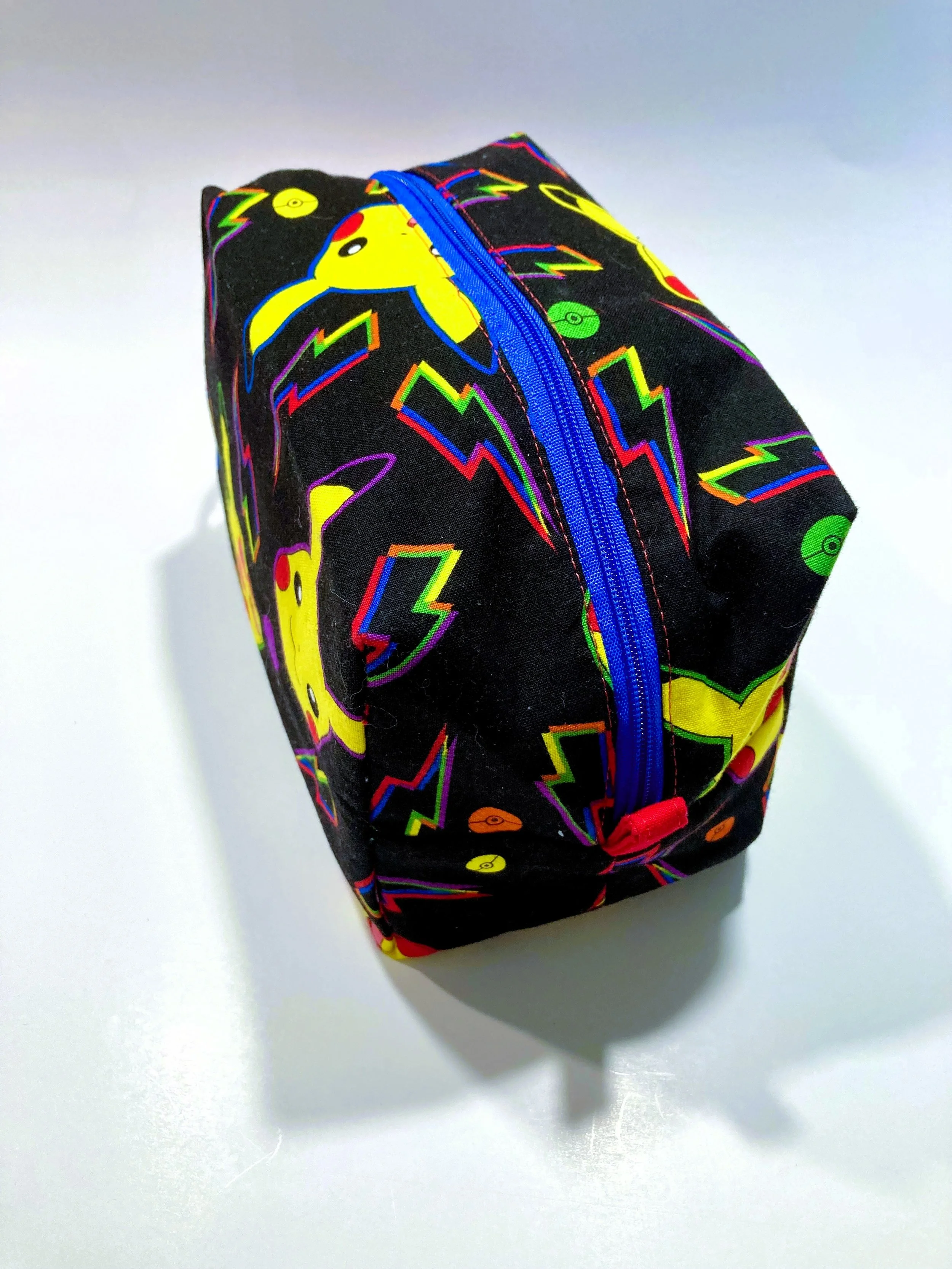Retro 90s Anime Mouse Travel Cosmetic Bag Vintage Gaming Illustration Makeup Case on Black Background Side View.jpeg