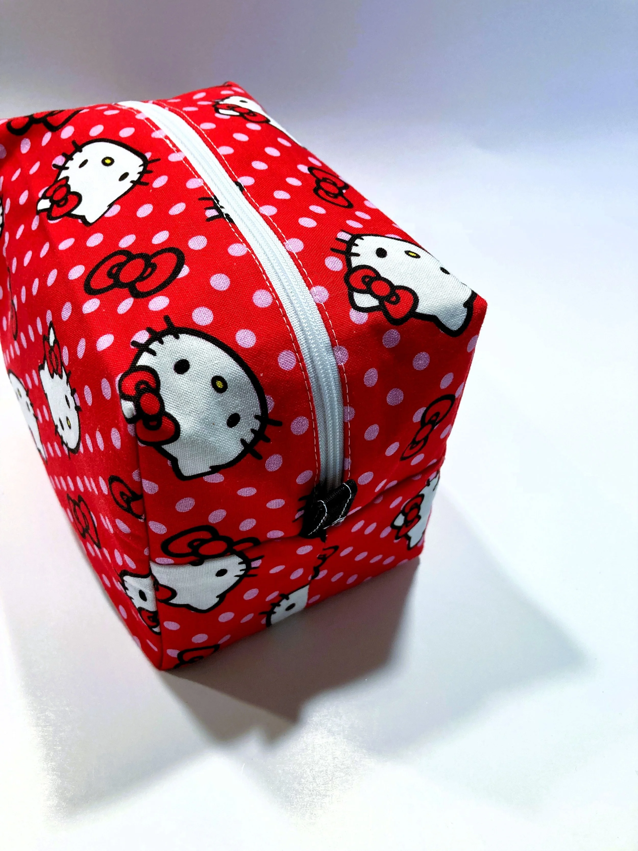 Classic Retro Kawaii Cat Travel Cosmetic Bag Vintage Cartoon Illustration Makeup Case on Vibrant Red Background Side View.jpeg