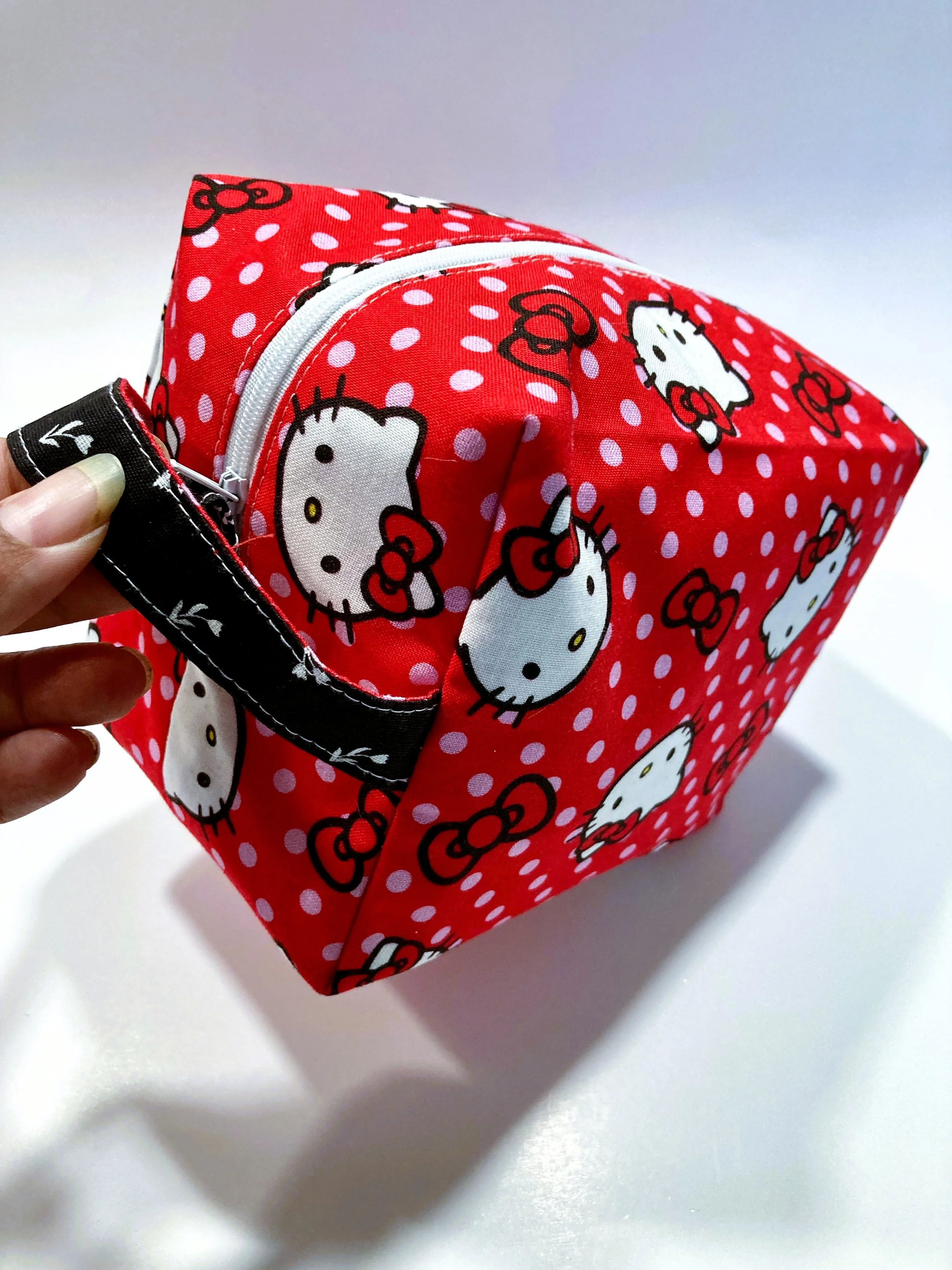 Classic Retro Kawaii Cat Travel Cosmetic Bag Vintage Cartoon Illustration Makeup Case on Vibrant Red Background Handle Front Angle View.jpeg
