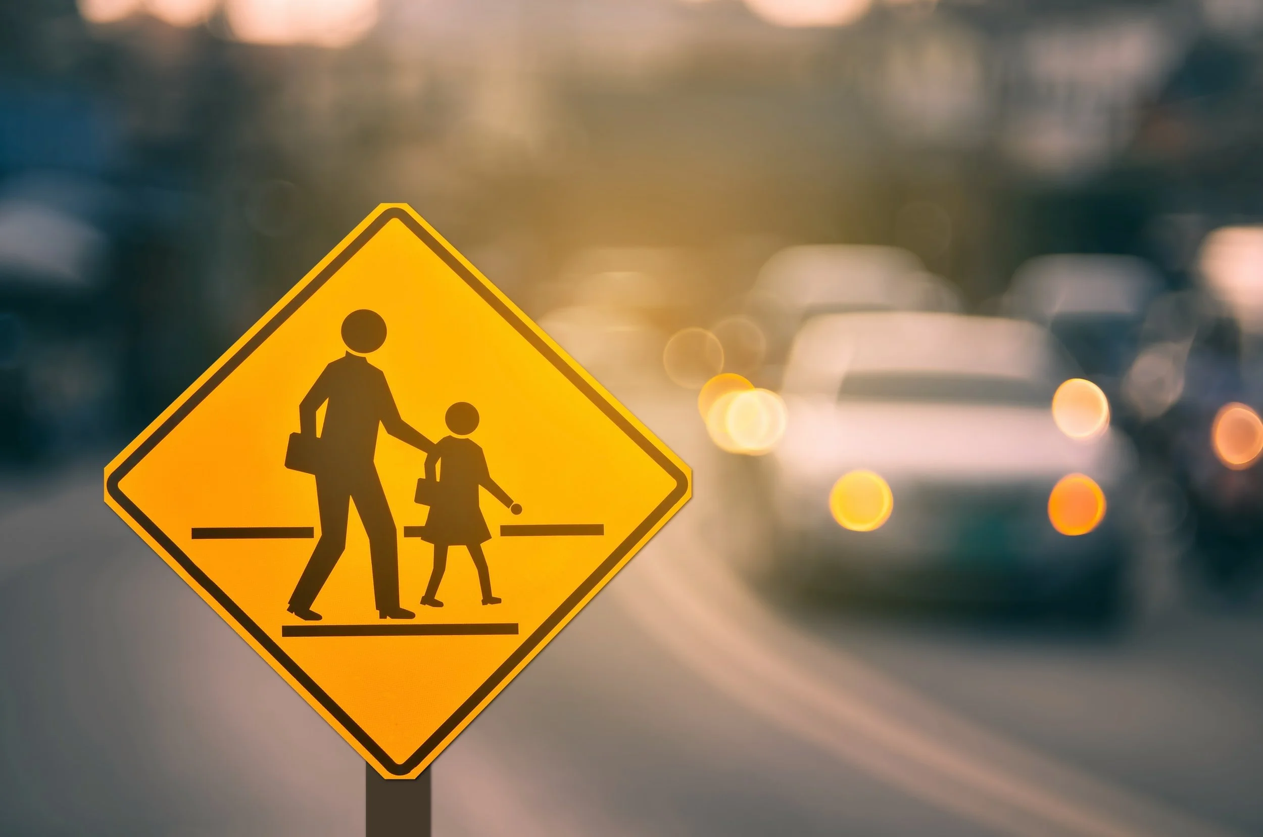 pedestrian crossing sign and boko lights with traffic in background