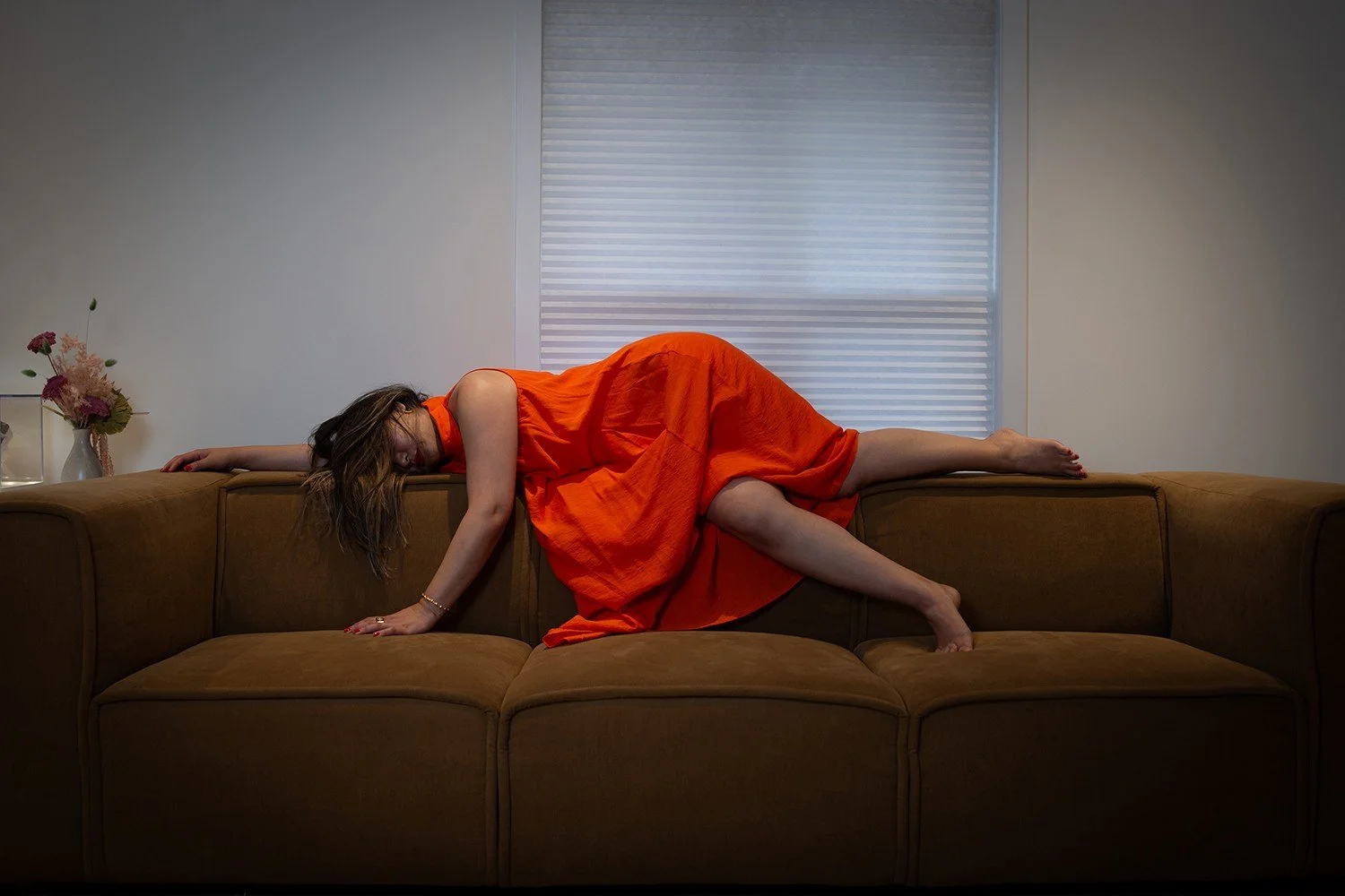 The Veiled Hours.

I lie on the couch in a beautiful, red silk dress. My hair falls across my face, obscuring my features until I become anonymous, a figure rather than a person, unknown perhaps even to myself. The concussion has erased more than my 