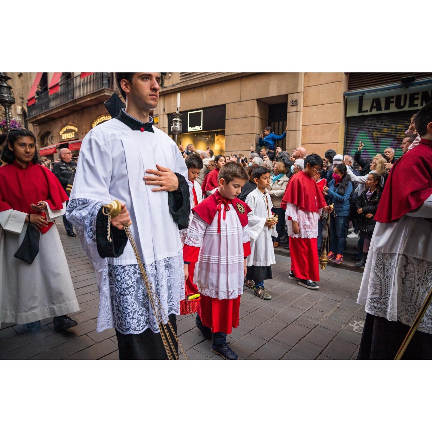 A crowd gathers to watch a Good Friday Easter procession outside the Iglesia de Sant Jaume this evening in Barcelona.