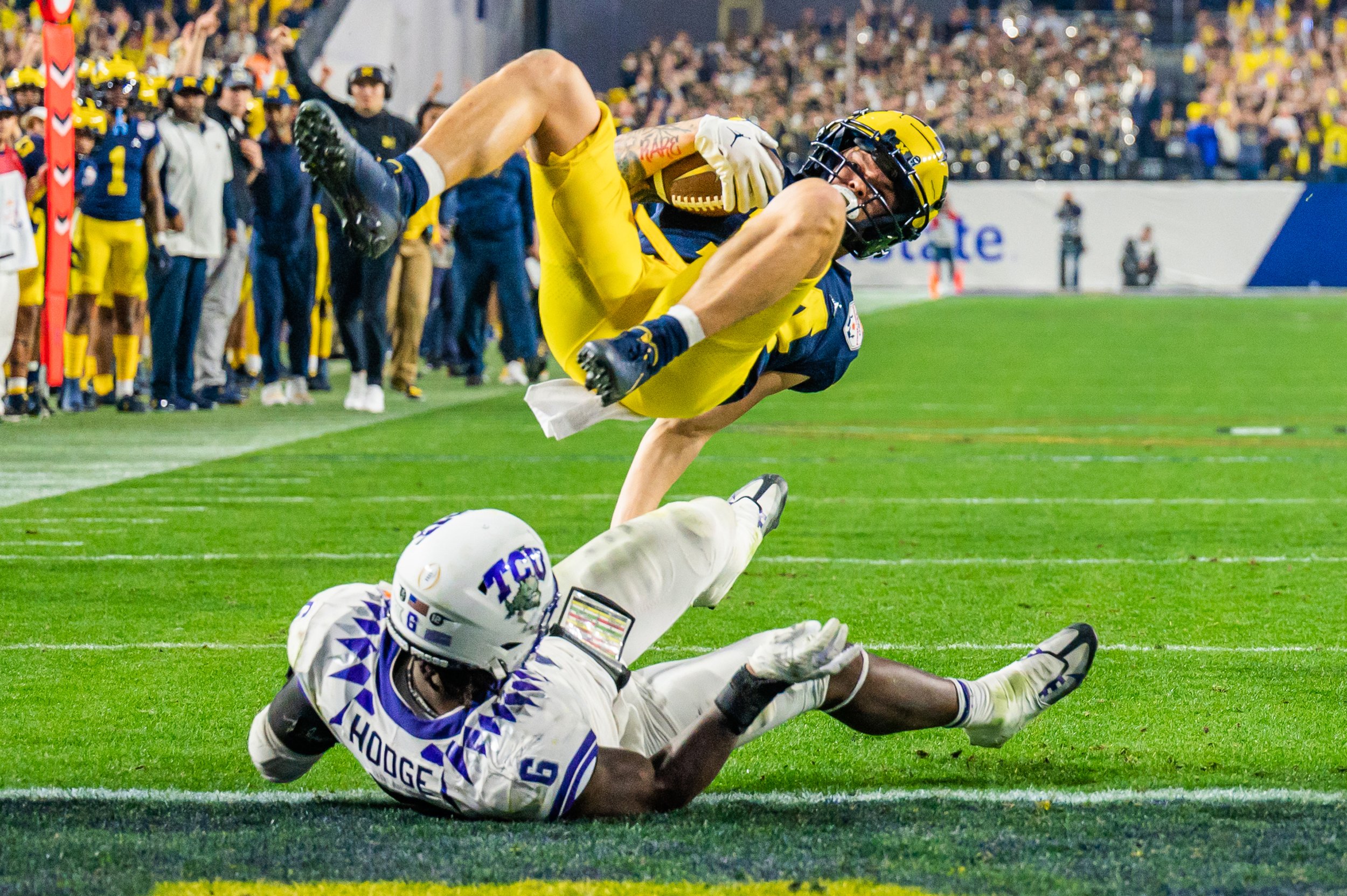 Roman Wilson (14) flips to score a touchdown against TCU at the Vrbo Fiesta Bowl College Football Playoff Semifinal in Glendale, Arizona on Saturday, December 31, 2022. Michigan would convert the 2-point conversion to make the score 41-38. Michigan 