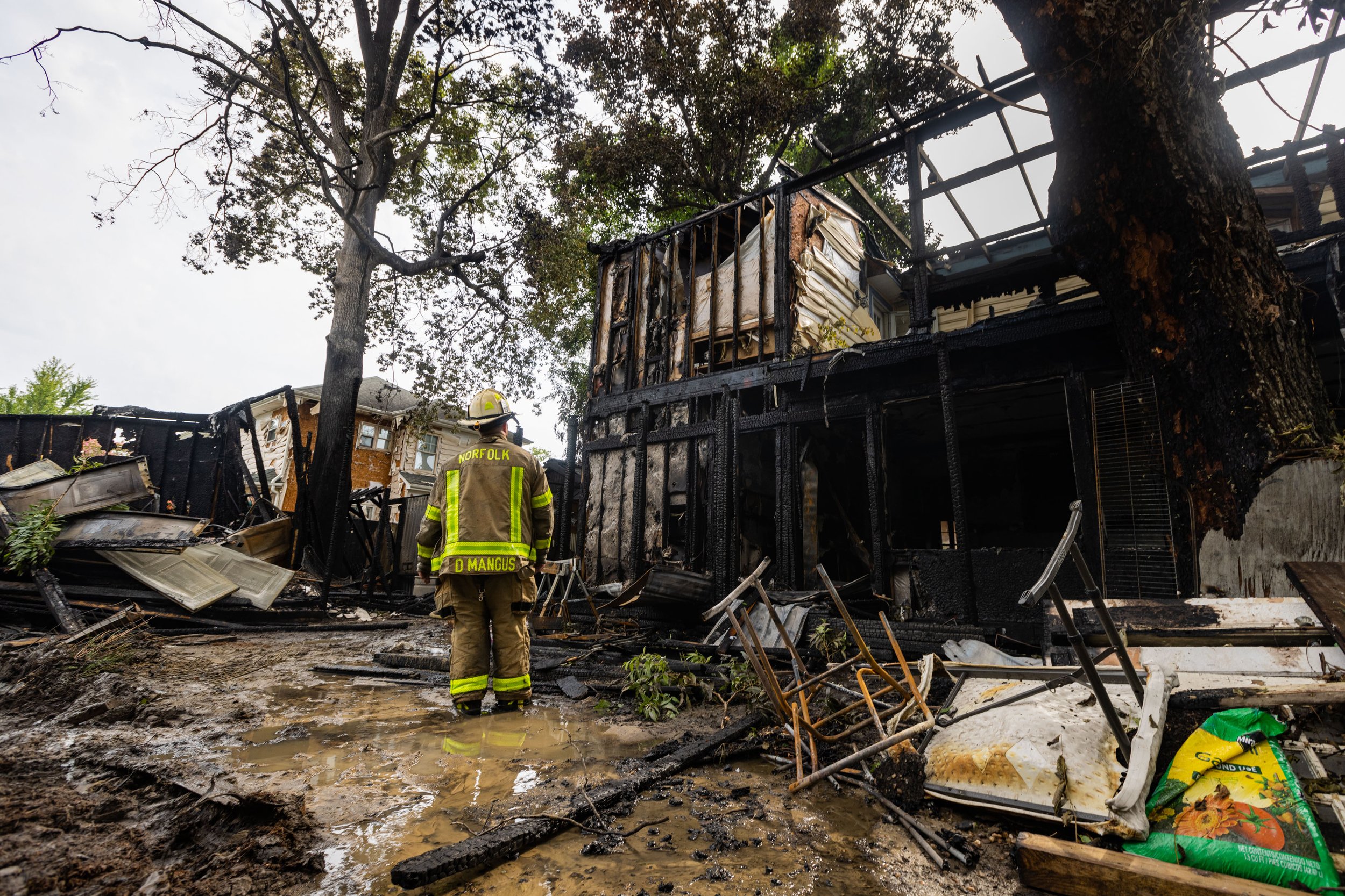  A firefighter surveys the damage to a home in the 9100 block of Granby Street from a fire early Monday morning in Norfolk, Virginia on Monday, August 14, 2023. Three homes were severely damaged by the fire. (Tess Crowley / The Virginian-Pilot) 