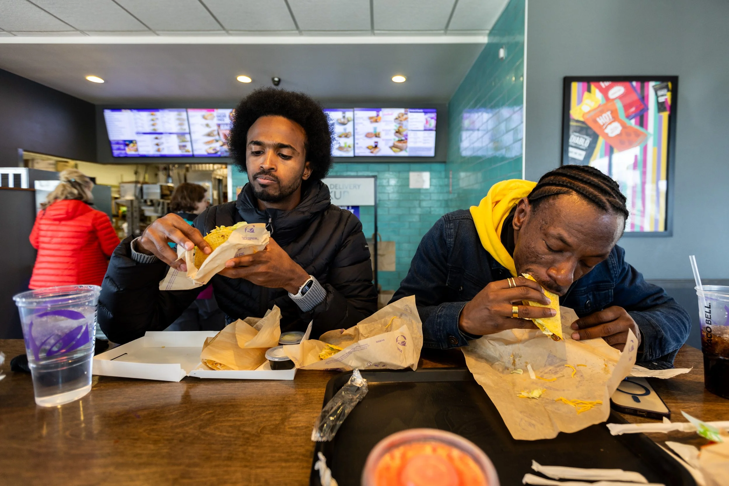  “Khartoum” directors Timeea Mohamed Ahmed, left, and Ibrahim Snoopy, right, eat lunch with fellow Sudanese directors Anas Saeed and Rawia Alhag at Taco Bell in Salt Lake City on Tuesday, Jan. 21, 2025. This is the Sudanese directors’ first time in t