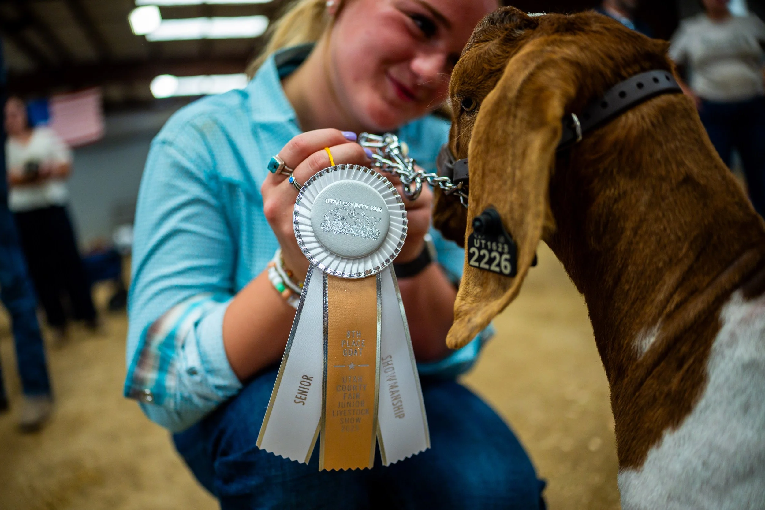  Charlotte Tibbals, 17, from Springville, hugs her goat after winning 8th place in the Senior Goat Showmanship at the Utah County Fair in Spanish Fork on Friday, August 1, 2025. 
