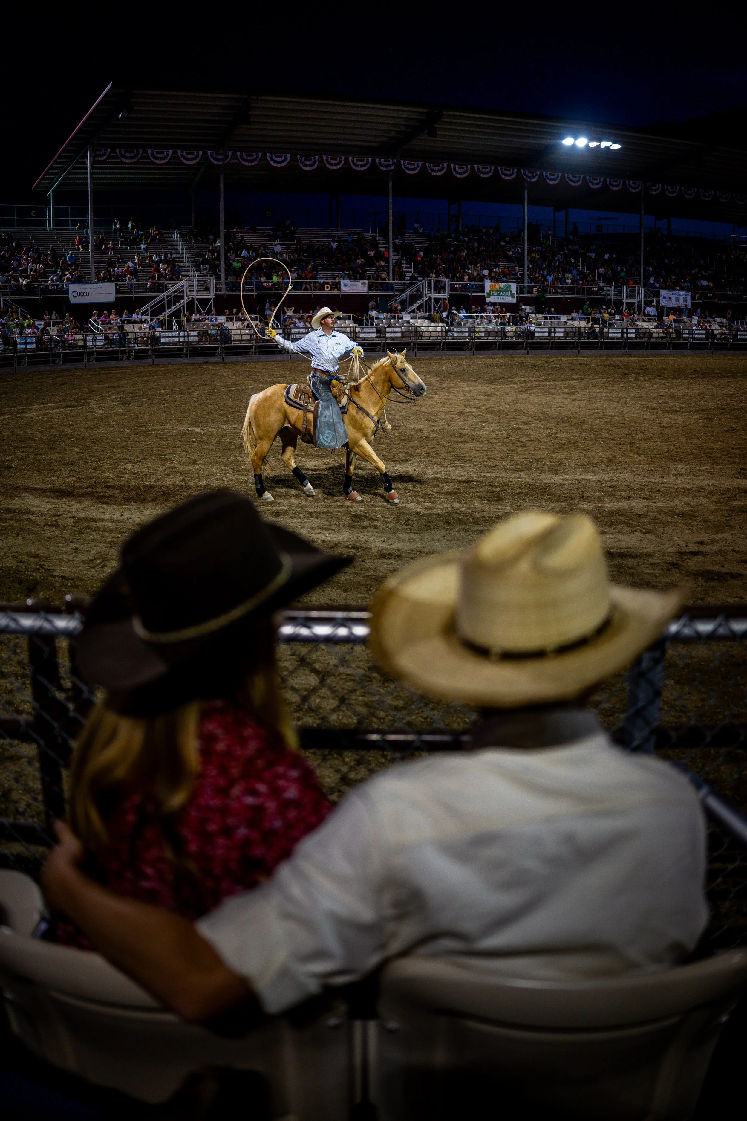  Gage Rowbury, 18, right, and his girlfriend Ella Barlow, 18, left, watch the Western Night Rodeo at the Utah County Fair in Spanish Fork on Thursday, July 31, 2025. 