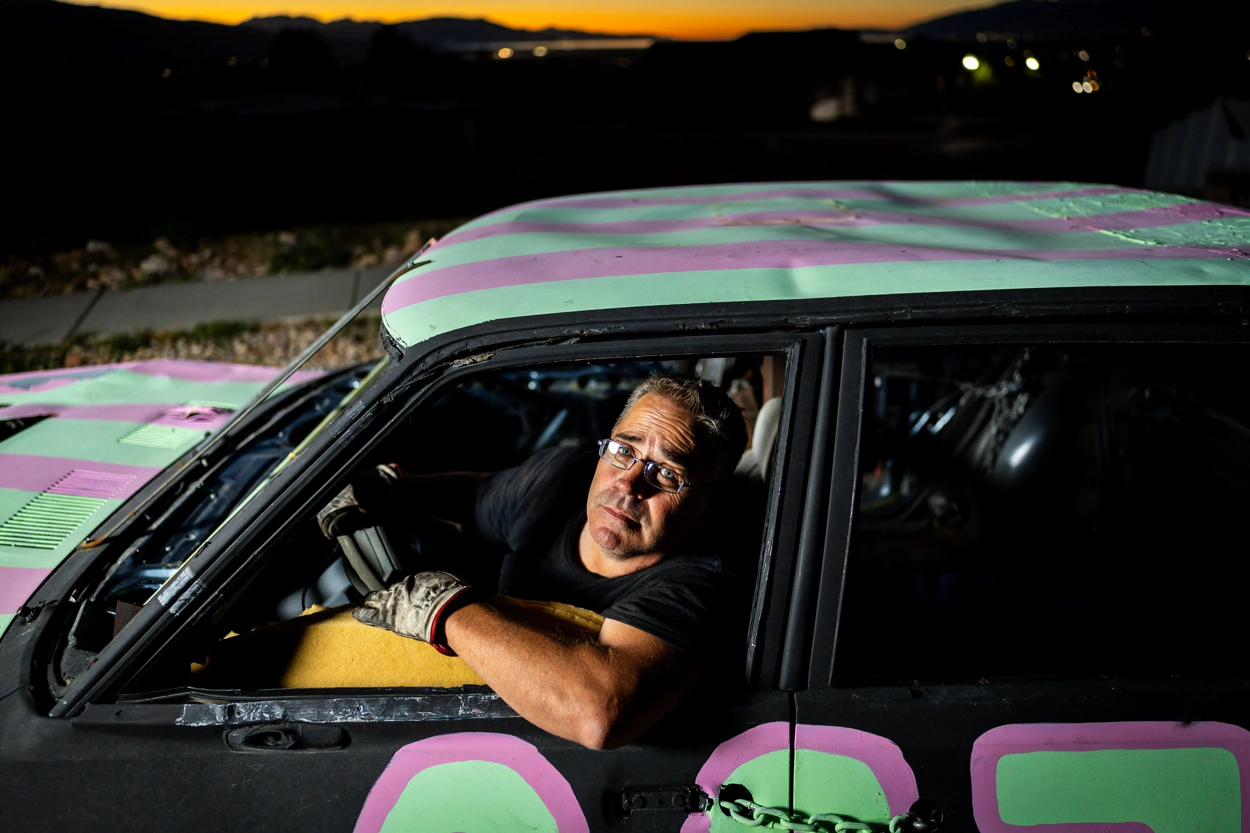  Jason Davis poses in his car outside his home in Elk Ridge on Monday, July 28, 2025, before driving it in the demolition derby at the upcoming Utah County Fair. Jason painted “007” on his car because his brother, Josh Davis, loves James Bond. “It’s 
