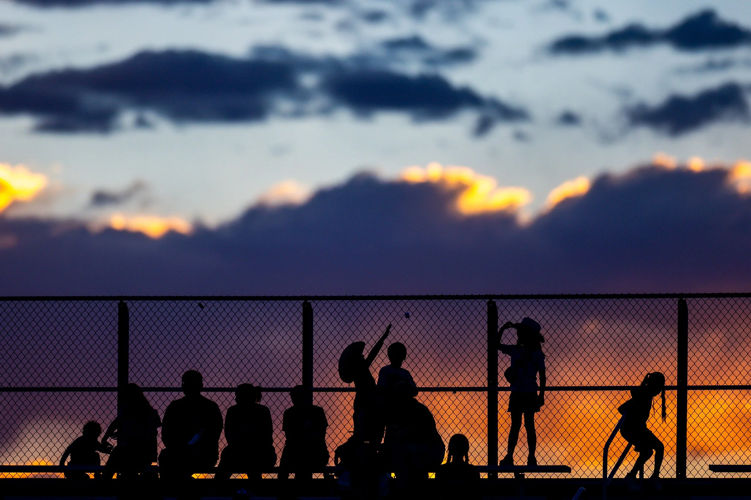  Rodeo spectators watch from the stands as the sun sets at the Western Night Rodeo at the Utah County Fair in Spanish Fork on Thursday, July 31, 2025. 