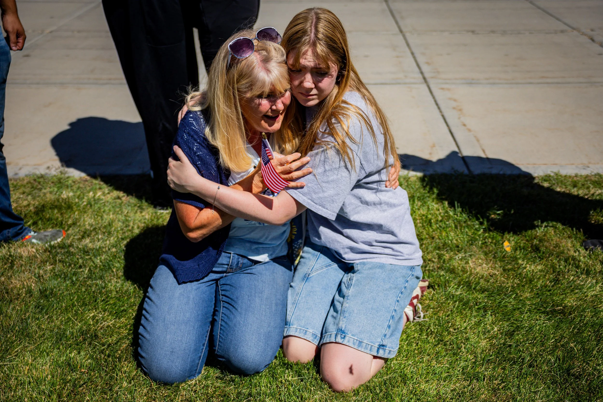  Strangers Cheryl Stout, left, and Charlotte Miller, right, comfort each other after Charlie Kirk is fatally shot during Turning Point’s visit to Utah Valley University in Orem on Wednesday, Sept. 10, 2025.   