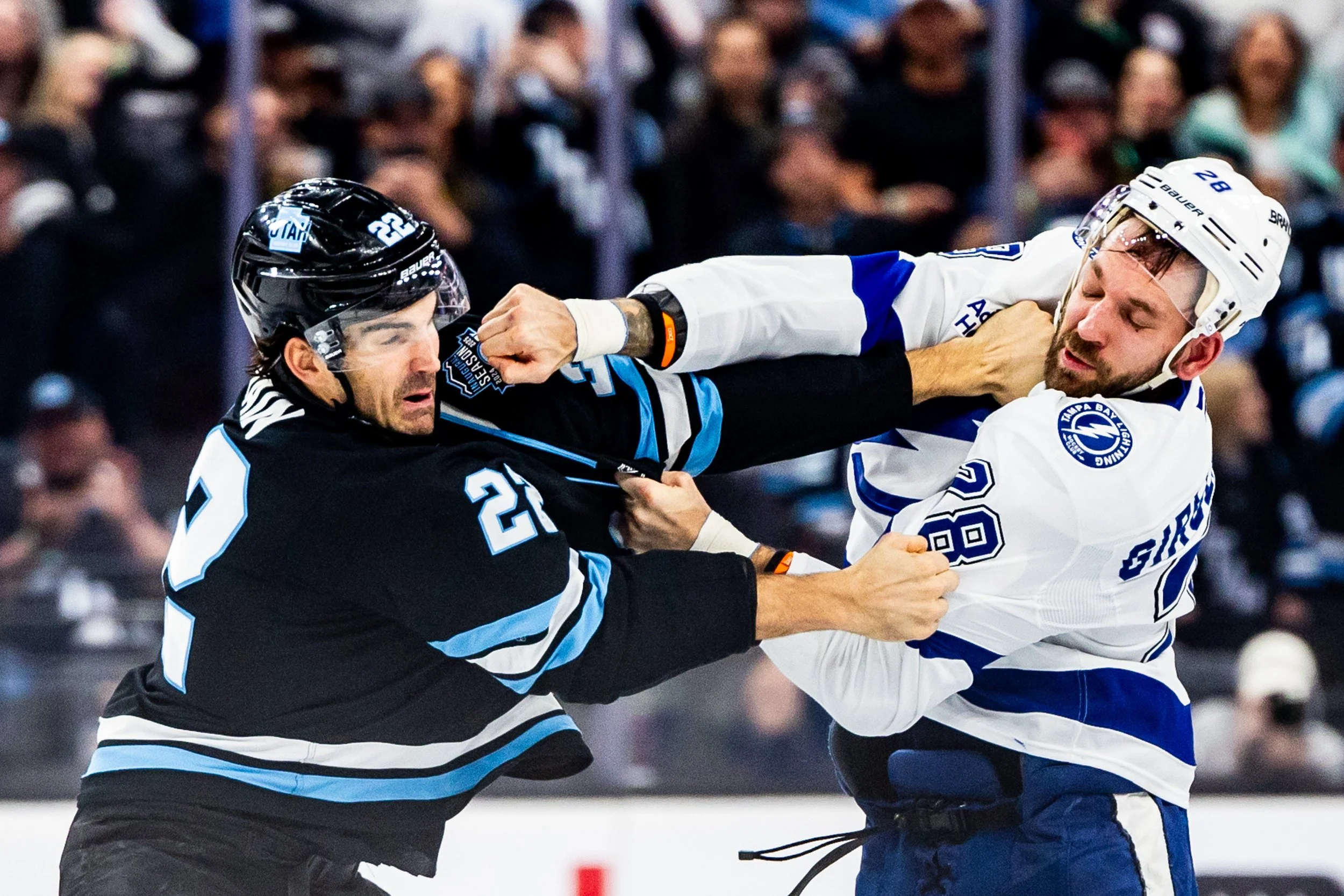  Utah Hockey Club center Jack McBain (22) and Tampa Bay Lightning center Zemgus Girgensons (28) engage in a fight during an NHL game at the Delta Center in Salt Lake City on Saturday, March 22, 2025. 