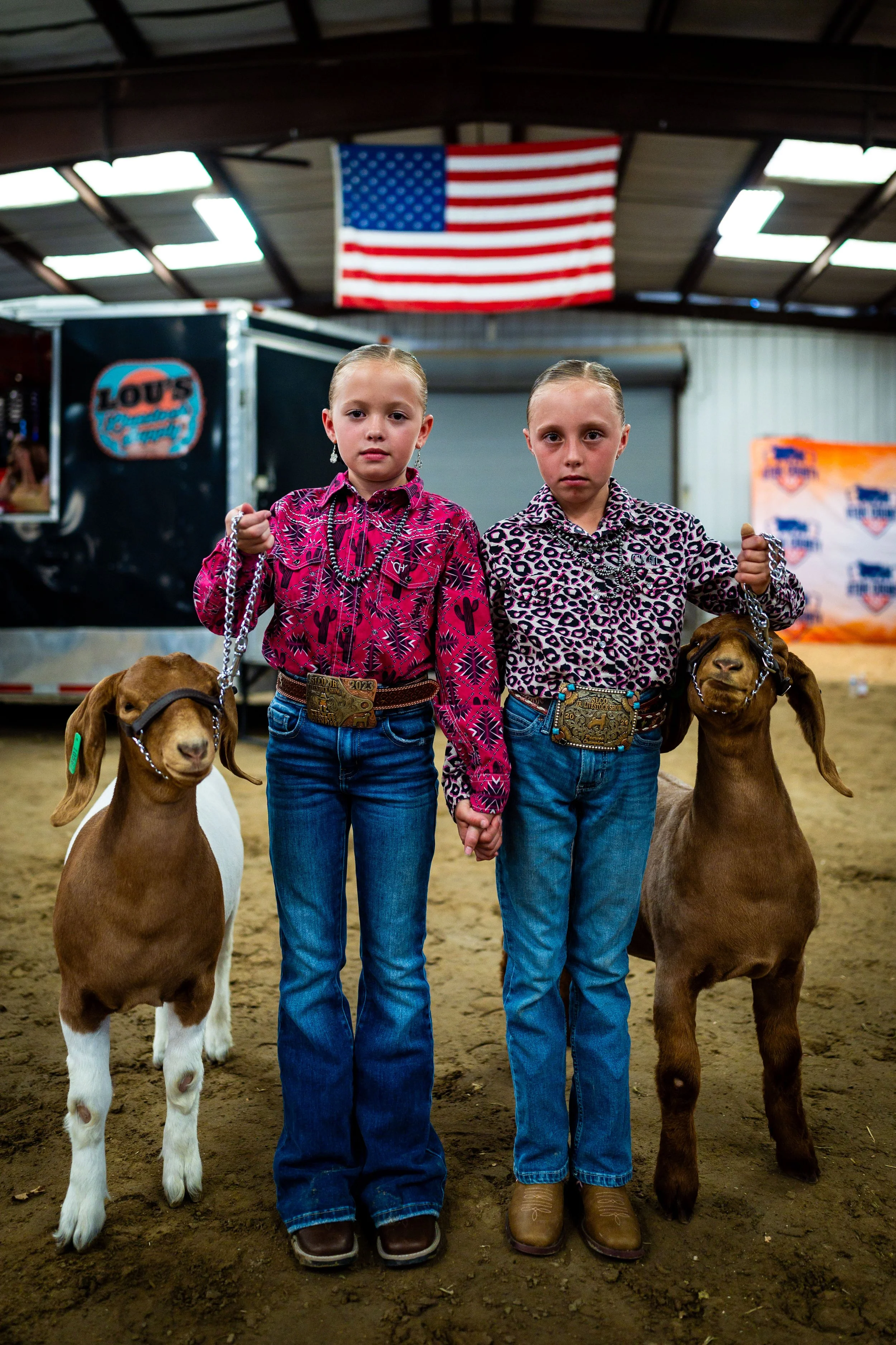  Twin sisters Nayvee Bateman, 9, left, and Brynklee Bateman, 9, right, pose with their goats before competing in Junior Goat Showmanship at the Utah County Fair in Spanish Fork on Friday, August 1, 2025. 
