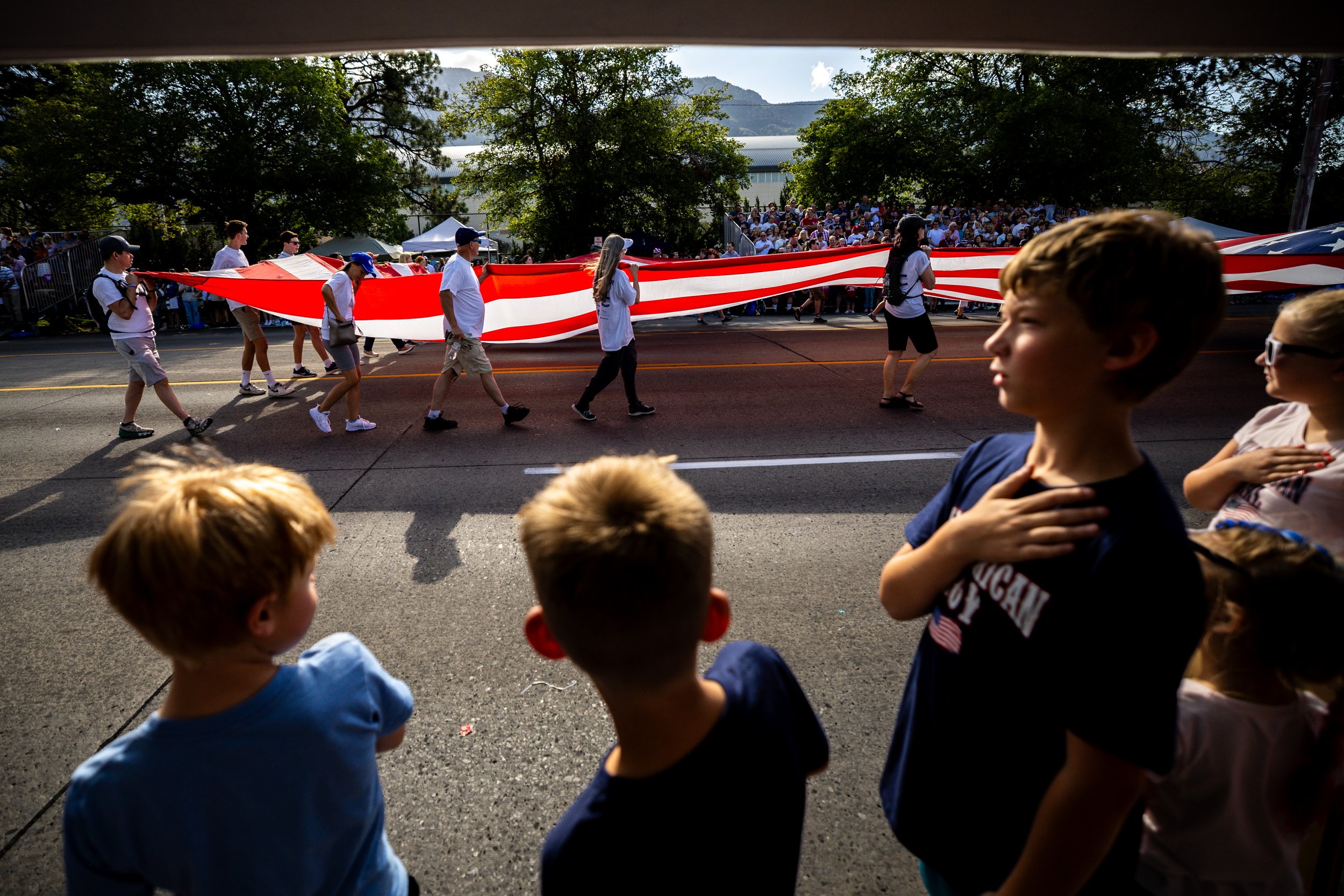  Brigham Holmstrom, 10, right, places his hand on his heart as the American flag is carried in the Freedom Festival Parade in Provo on Friday, July 4, 2025. 