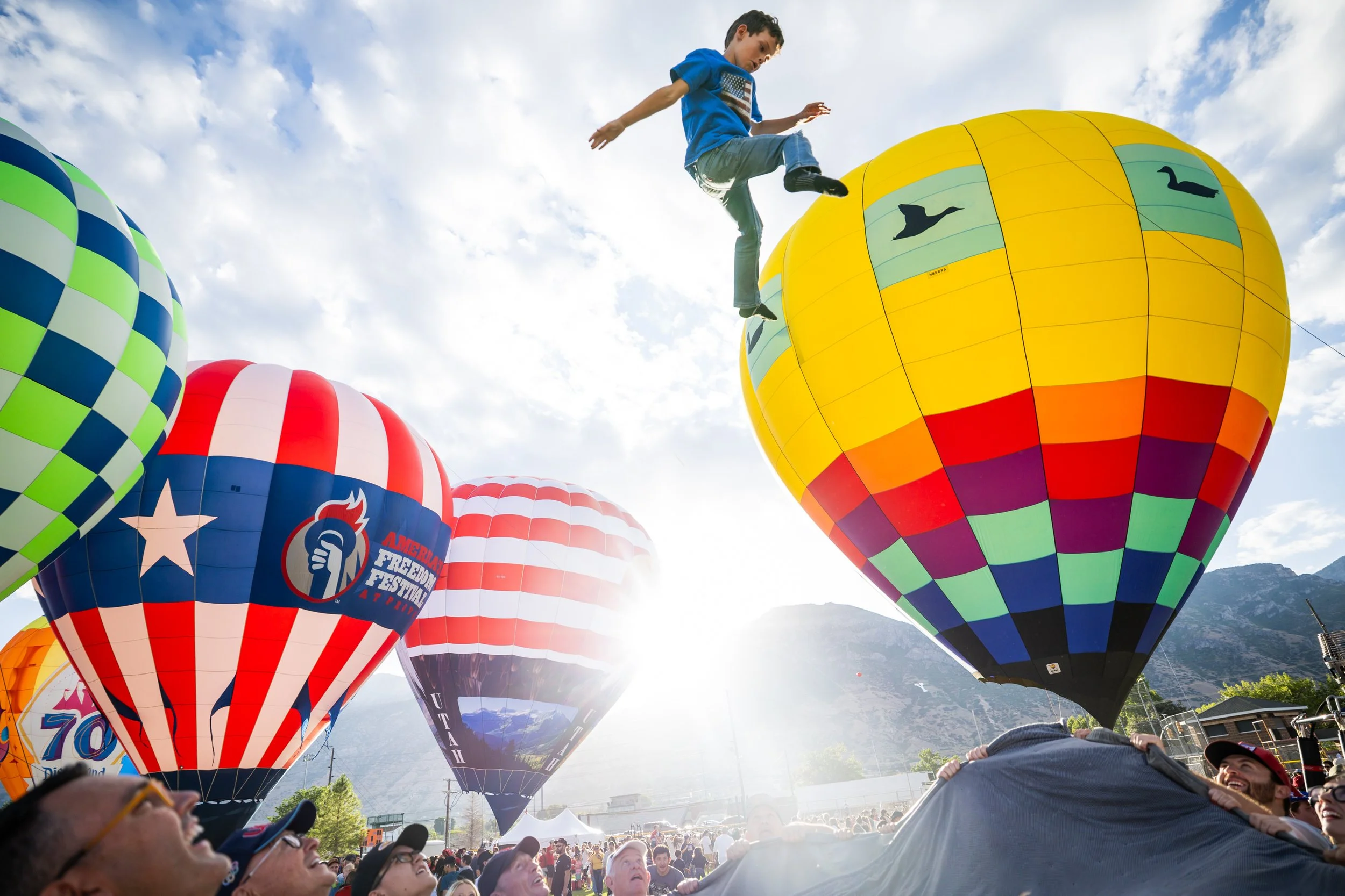  McKay Brink, 7, is lifted into the air at the Freedom Festival Balloon Fest  in Provo on Friday, July 4, 2025. 