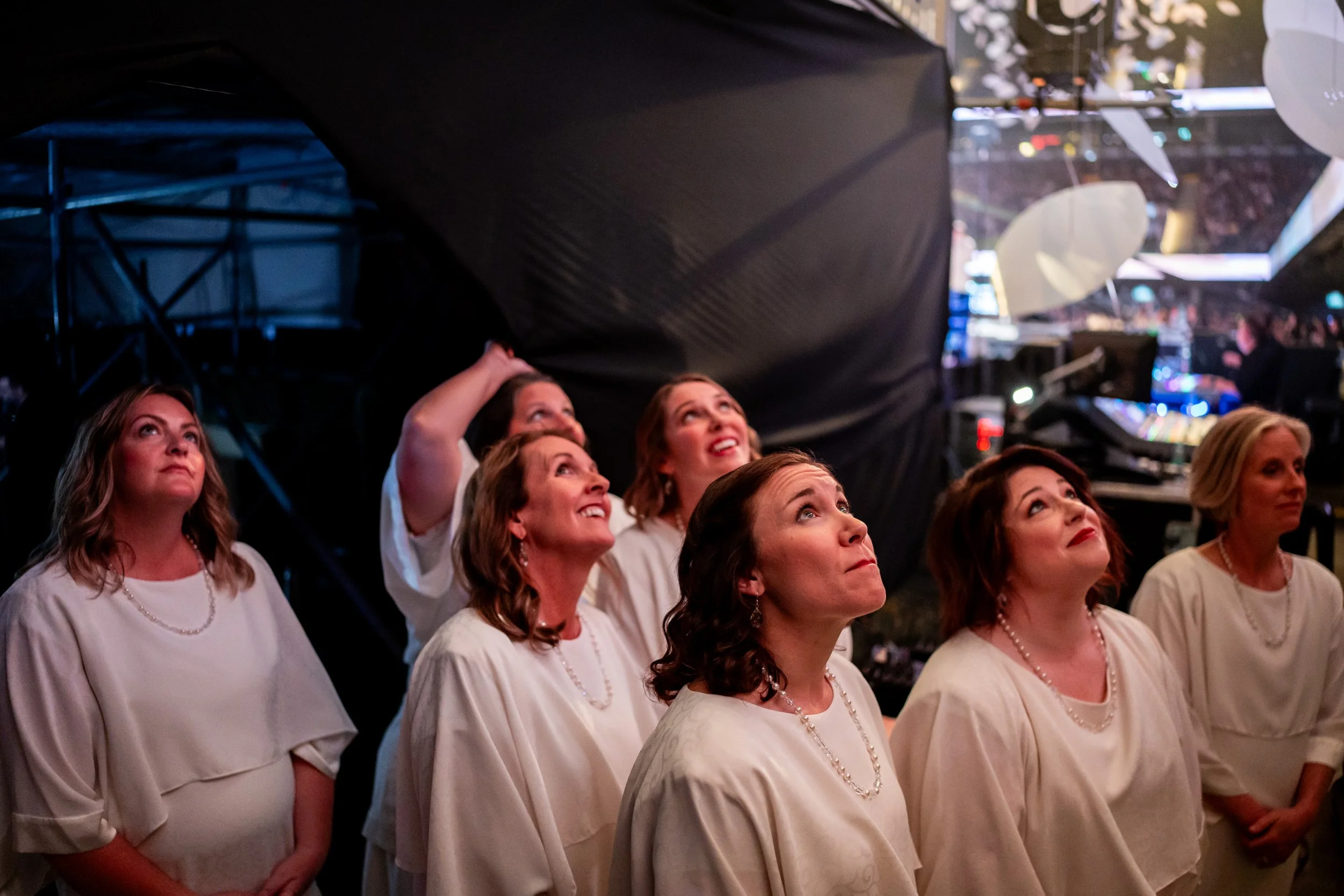  Members of The Tabernacle Choir and Orchestra at Temple Square watch the pre-show on a screen backstage before performing in a concert as part of the Tabernacle Choir “Songs of Hope” world tour at Movistar Arena  in Buenos Aires on Friday, Aug. 22, 
