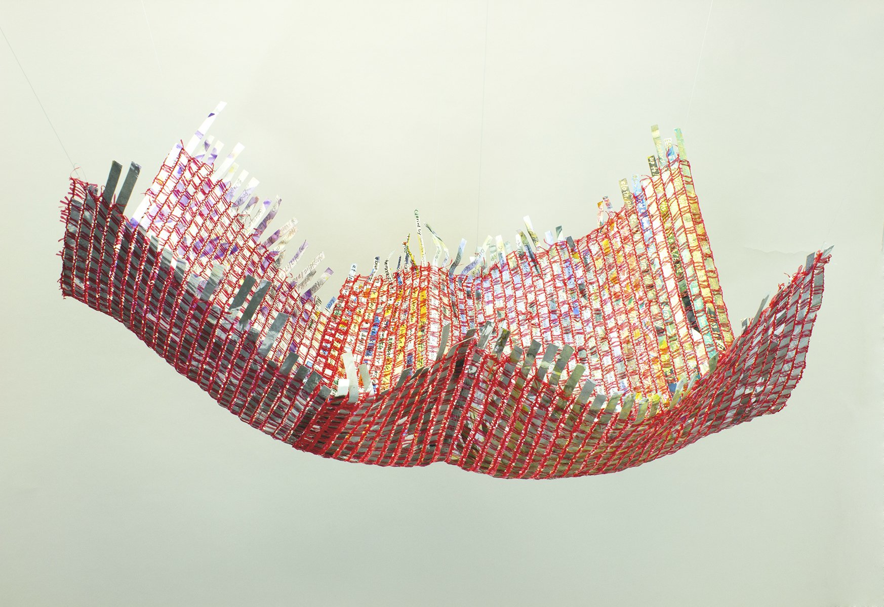Virginia Mahoney, Cradle, acrylic and words on reclaimed paper woven into reclaimed food net, approx. 13"x21"x28"