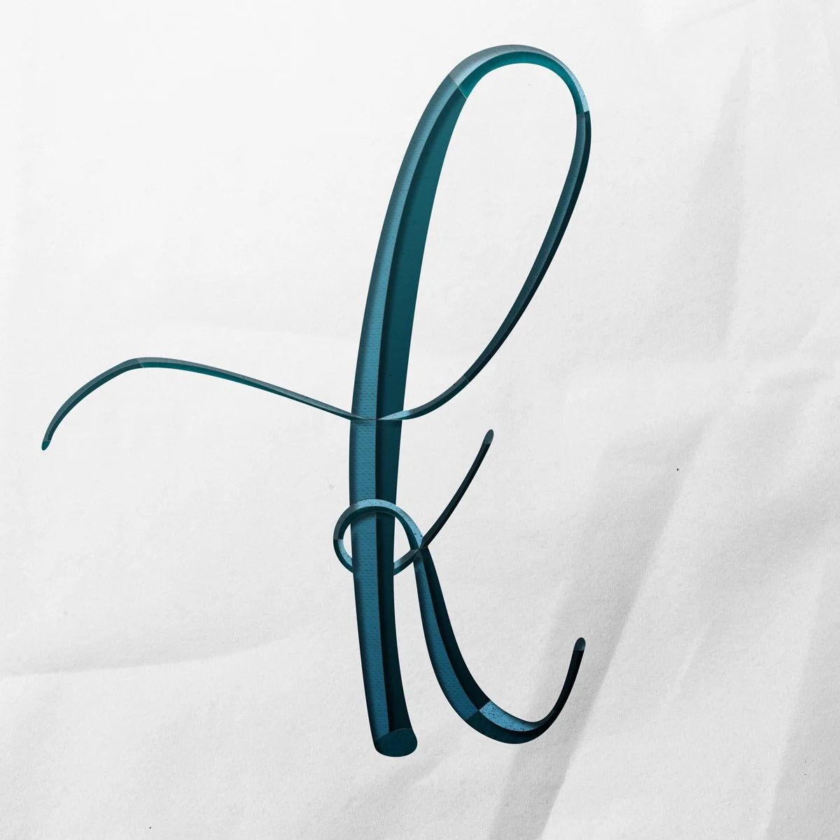 Cursive Lowercase letter k cut out from paper