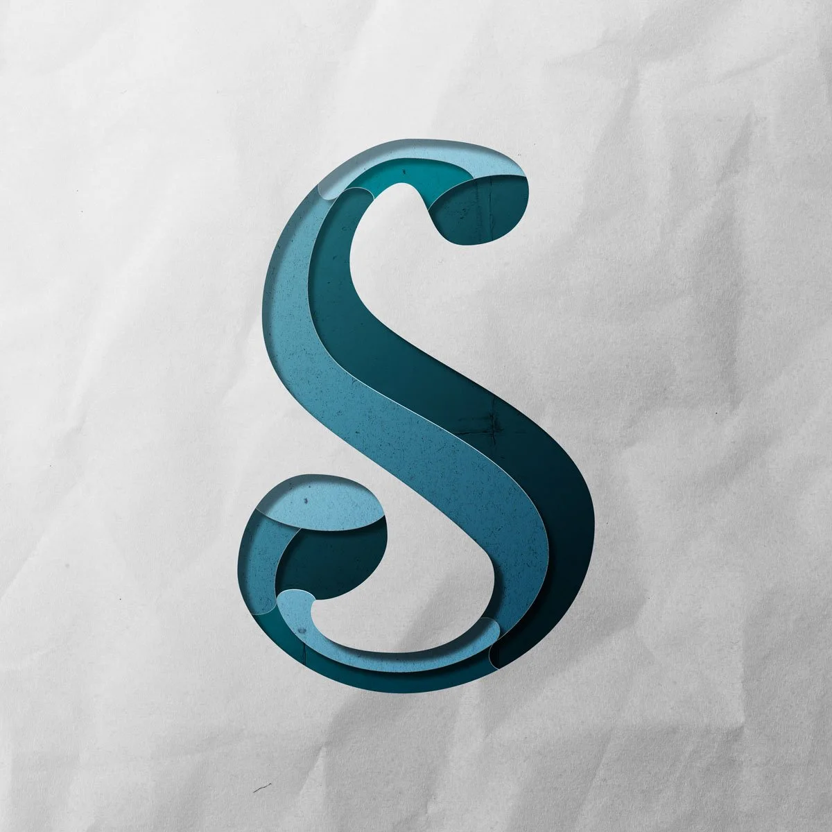 Capital letter S cut out from paper