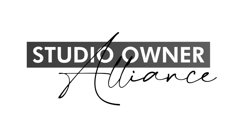 A photo of a black and white sign with the words "STUDIO OWNER" printed in bold white letters on a gray background.